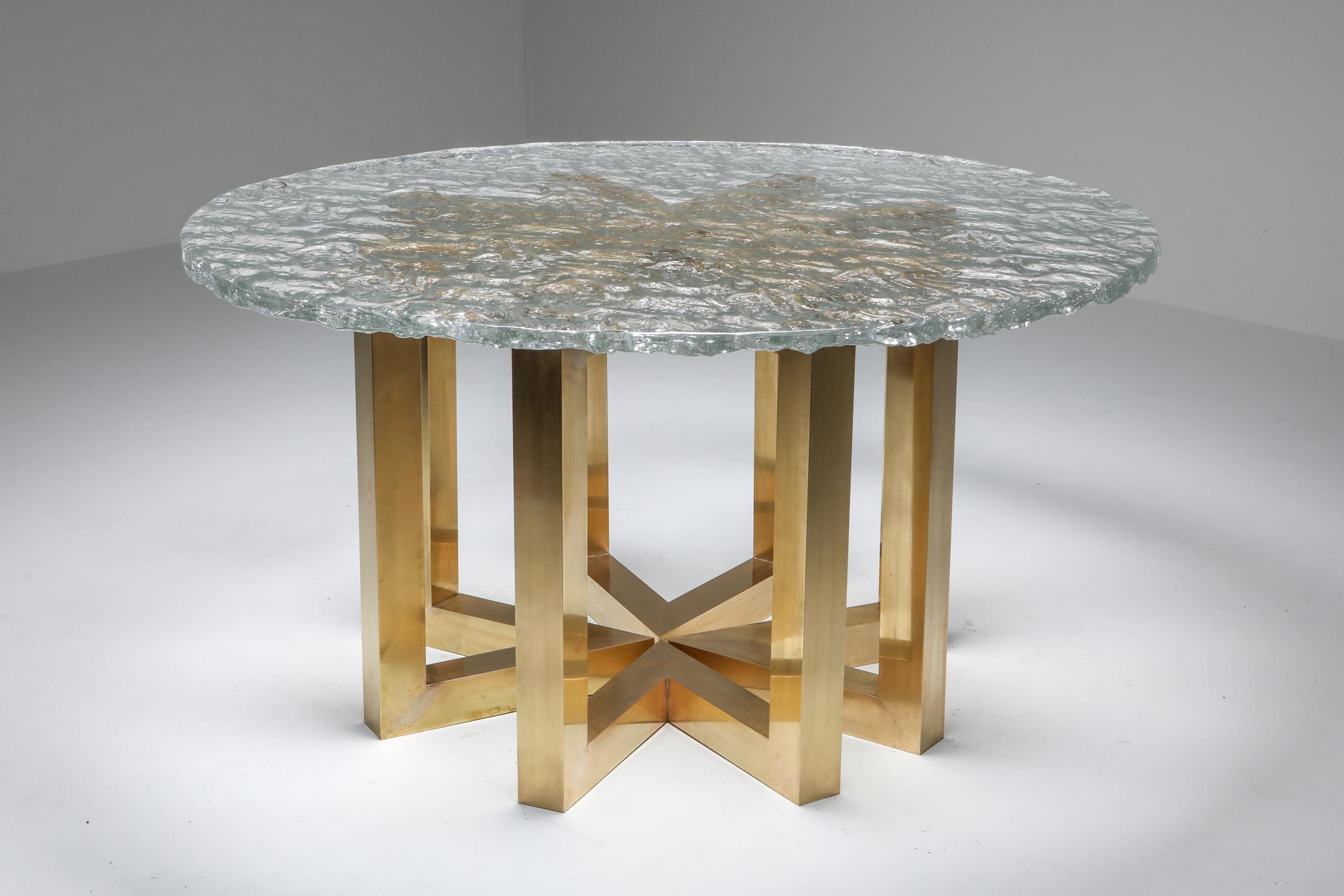 Poliarte table, brass segmented base and hand casted glass top dining table, Italy, 1970s

One of the most impressive tables in the current collection.
Murano hand forged glass top mounted on four brass triangular segments.
Ø 155 cm it fits six