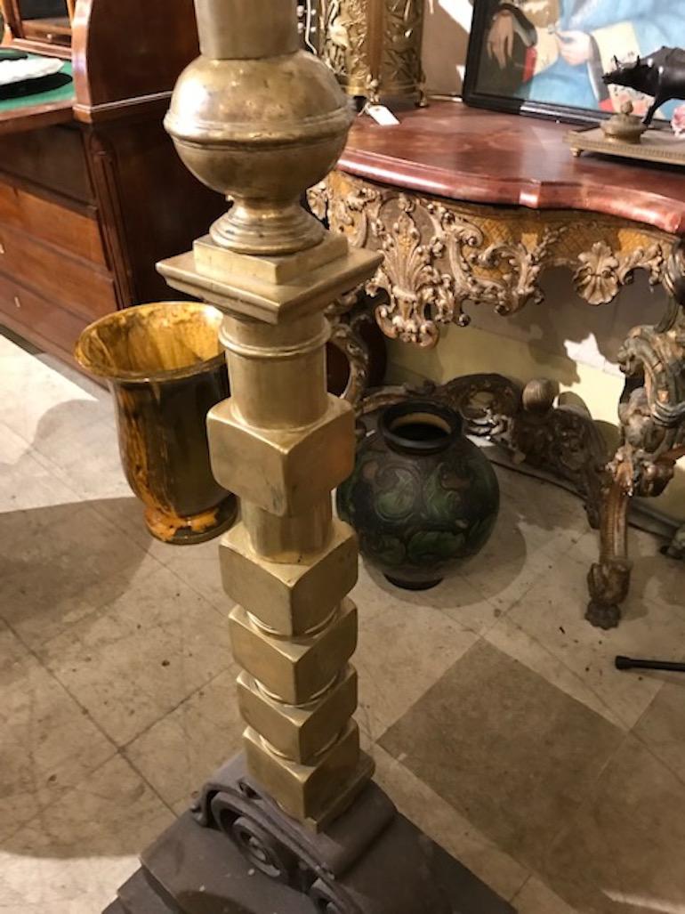 Brass and cast iron andiron mounted on a wood base as a floor lamp. In the manner of James Mont. Note: We have a shorter version of this lamp.
