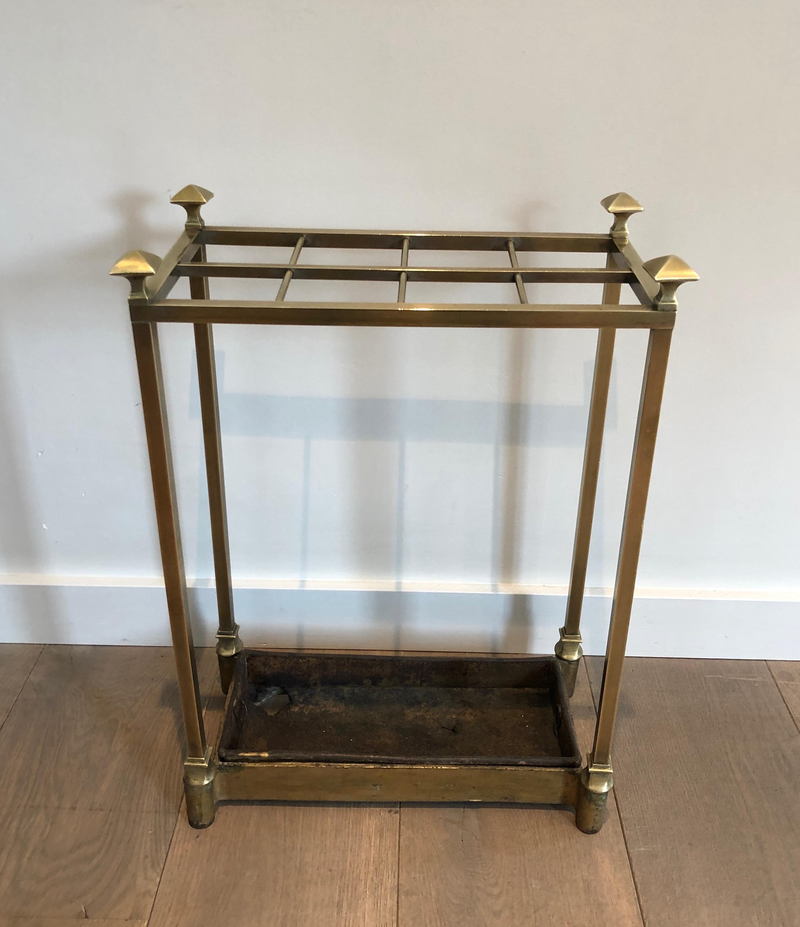 This umbrella stand is made of brass with a black metal part on the base. This is a French work, circa 1900.