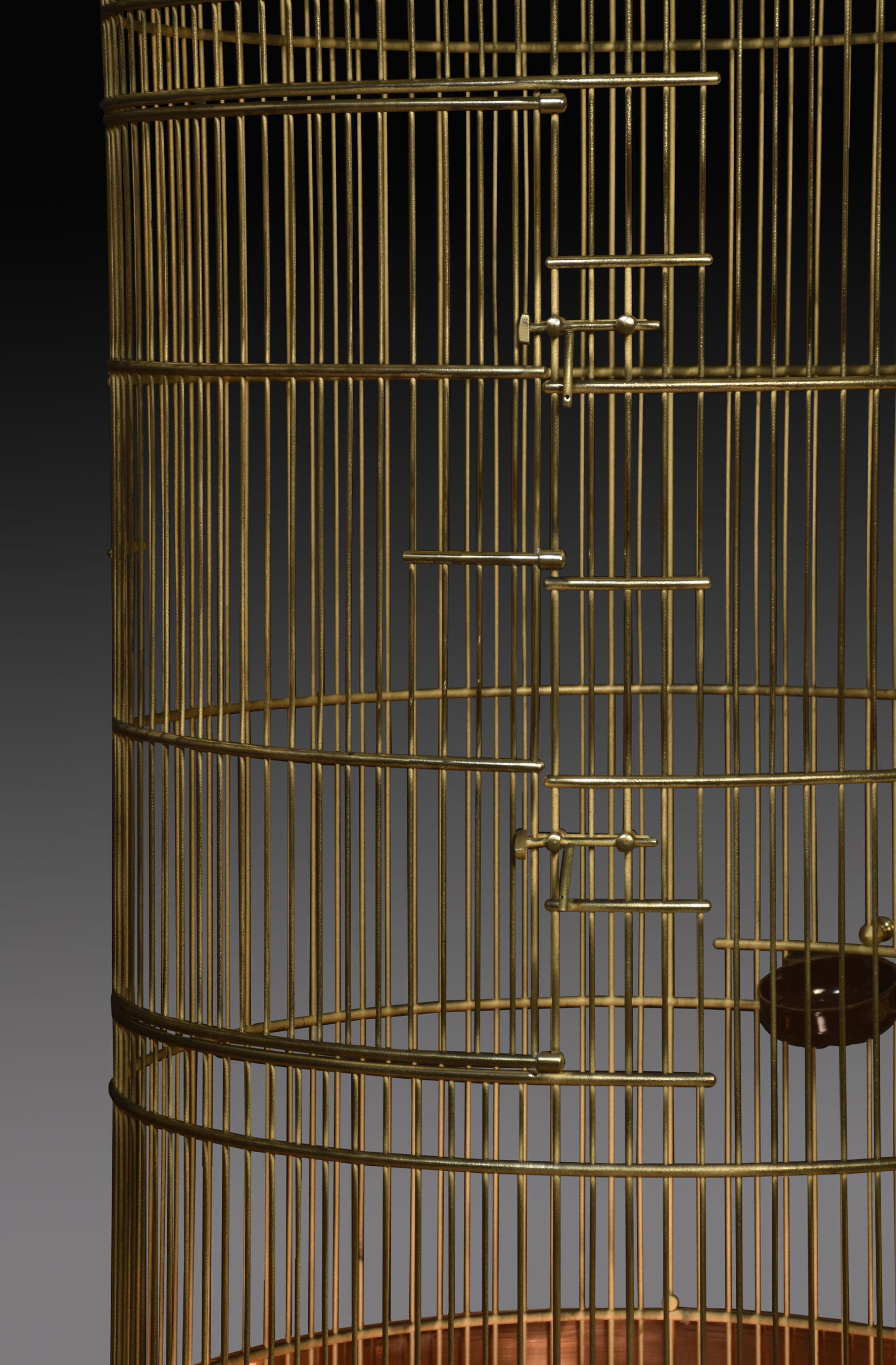 Brass and copper bird cage having a dome-shaped cage resting on a circular stepped copper base.
Dimensions
Height 75 Inches
Width 25 Inches
Depth 25 Inches

Cage Dimensions
Height 55.5 Inches
Width 24 Inches
Depth 24 Inches.