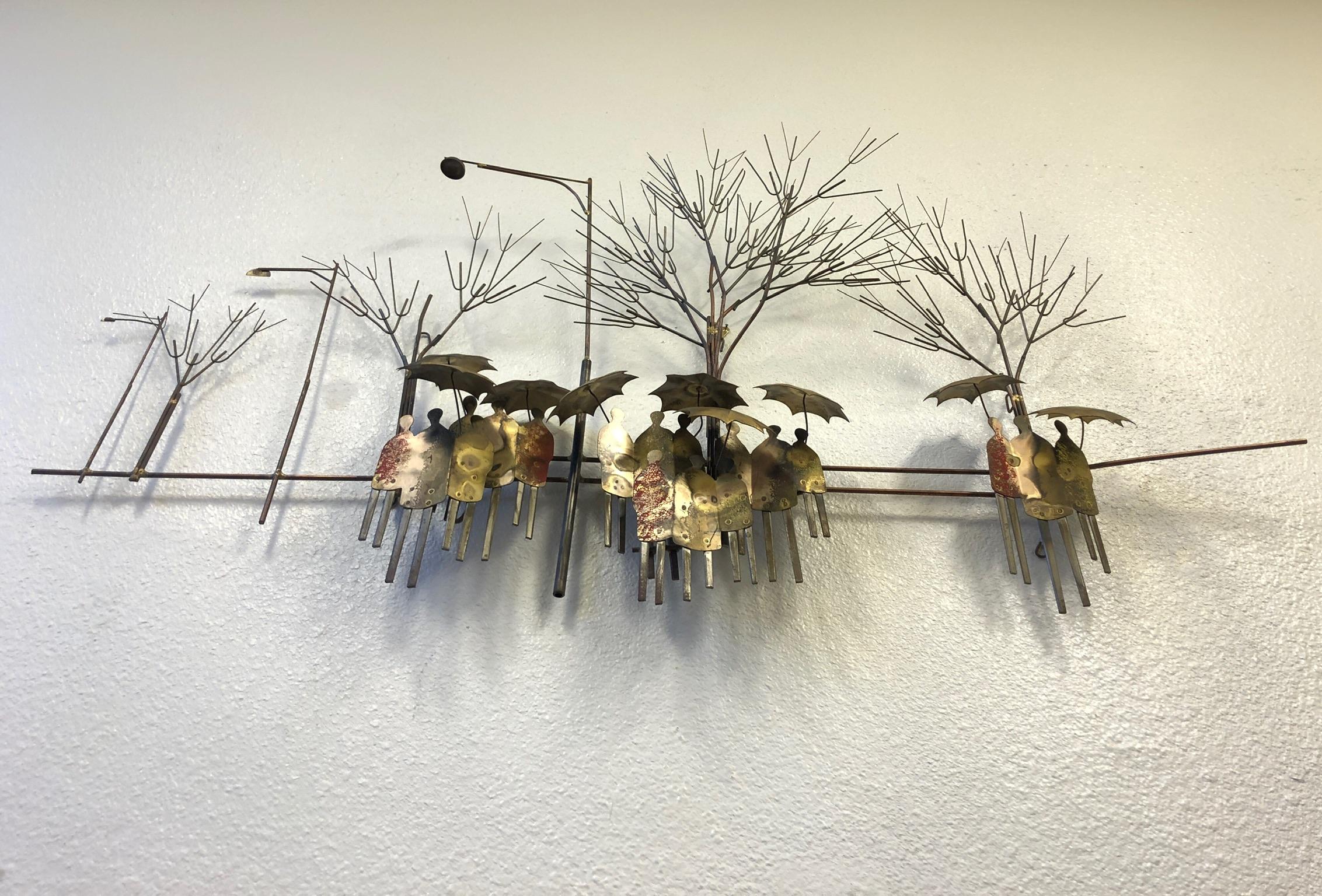 A beautiful 1970s wall sculpture depicting a rainy street scene by Curtis Jere. The sculpture is constructed of mix metals like brass, copper and steel. The sculpture is hand signed in the front and it has copper plate on the back.
Overall
