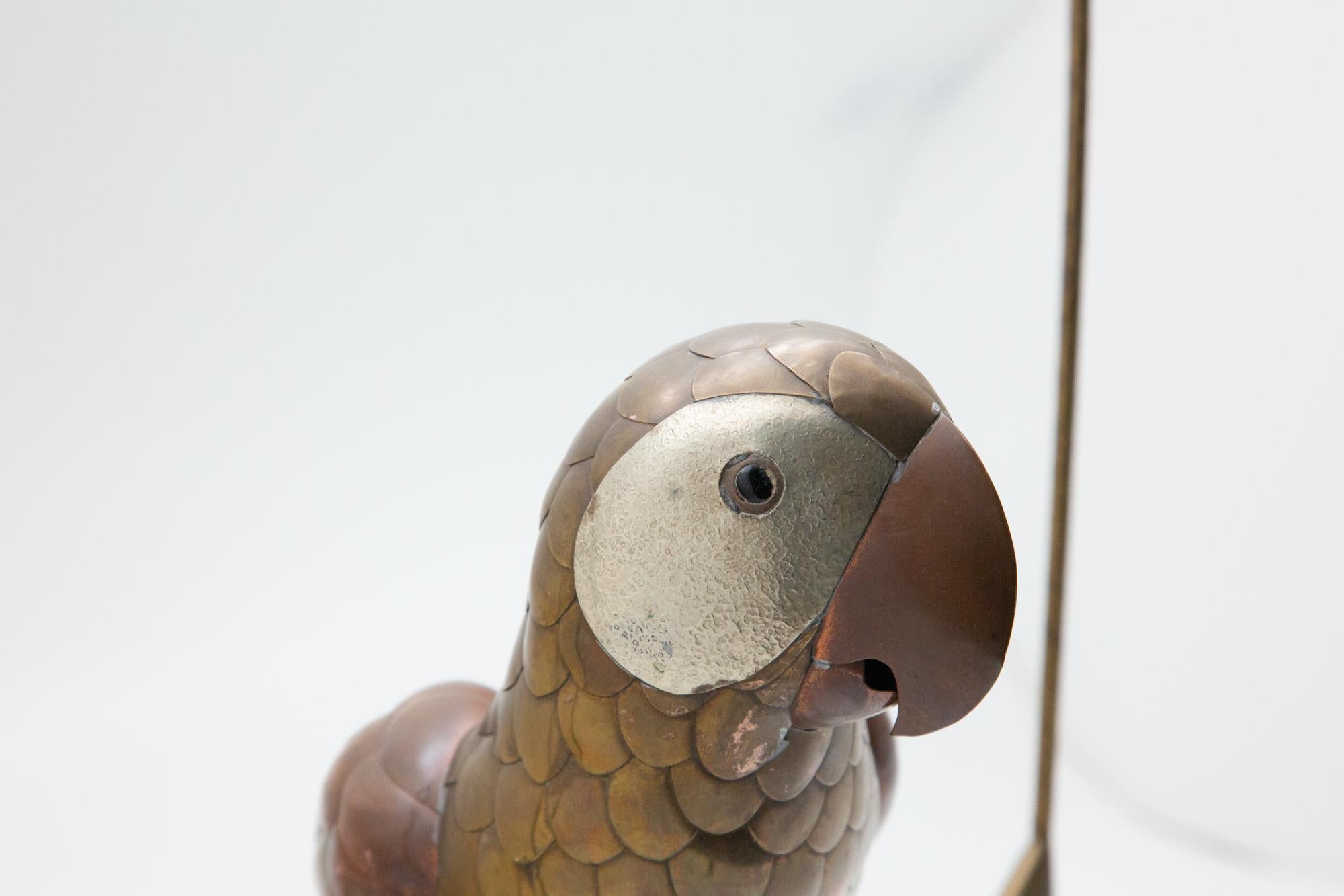 Brass and copper parrot in the style of Bustamente. Parrot sits on birdcage swing 12