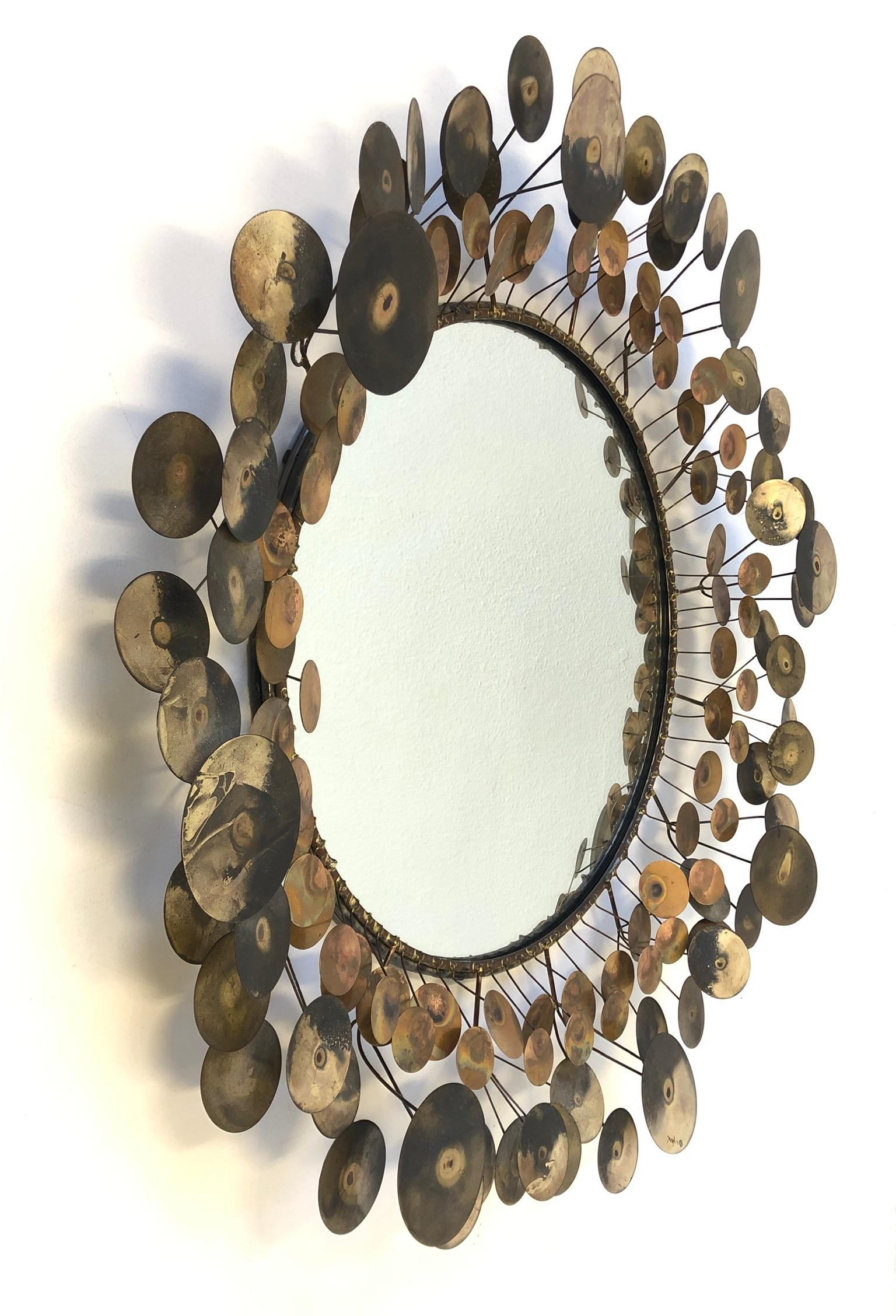 A glamorous 1970s “raindrops” mirror design by Curtis Jeré for Artisan House.
The frame is constructed of brass and copper. The mirror is in original condition, it retains the beautiful patina and signature. 

Measurements: 34” diameter and 5”