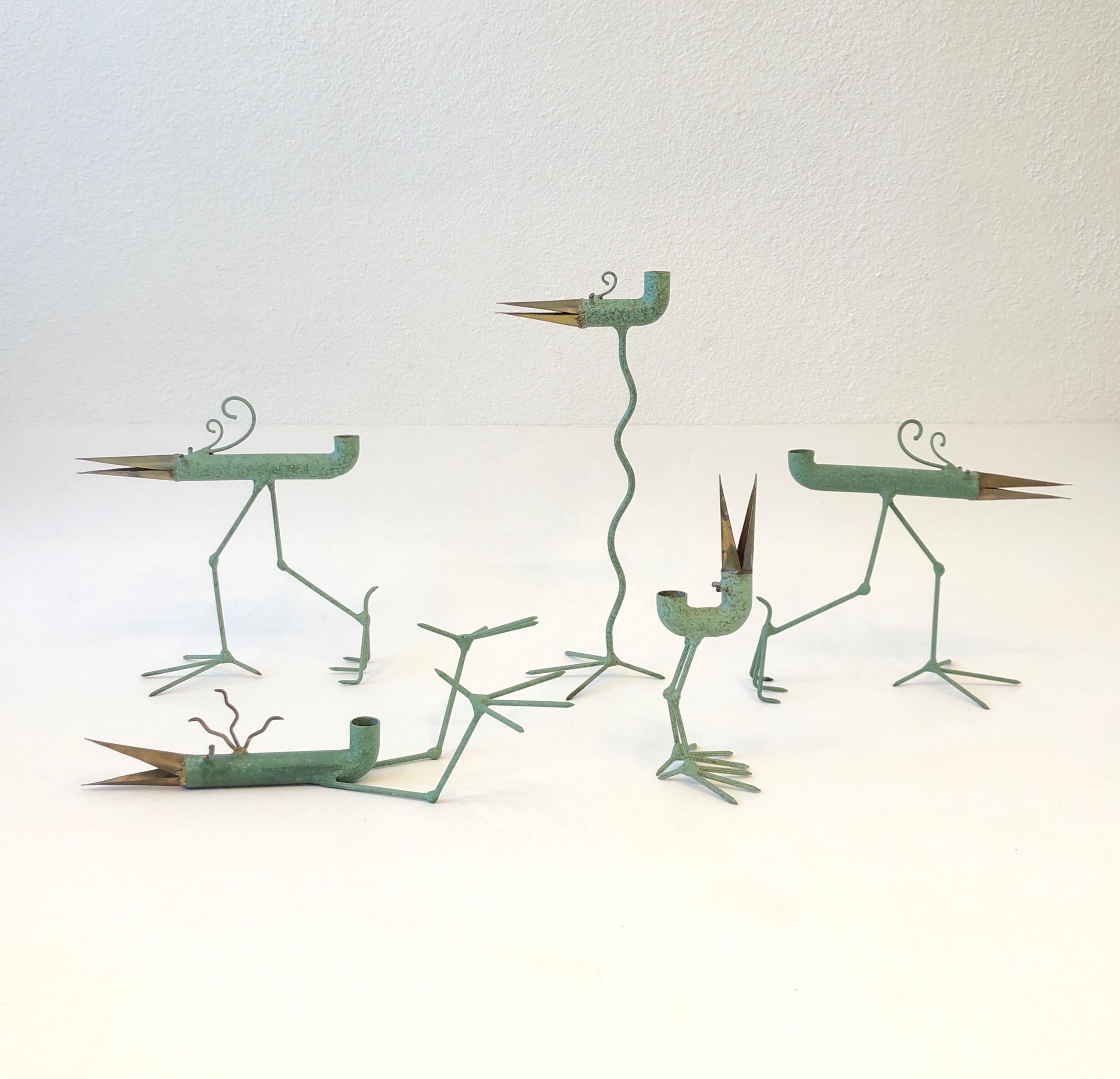 Collection of five whimsical sculptural birds candle holders by architect Gino Bushini.
Constructed of copper, brass and steel with a verdigris patina finish. 
They are all hand signed Bushini. 
Measurements: 
L-14.75” H, 5” D, 6” W.
M-10.5” H,