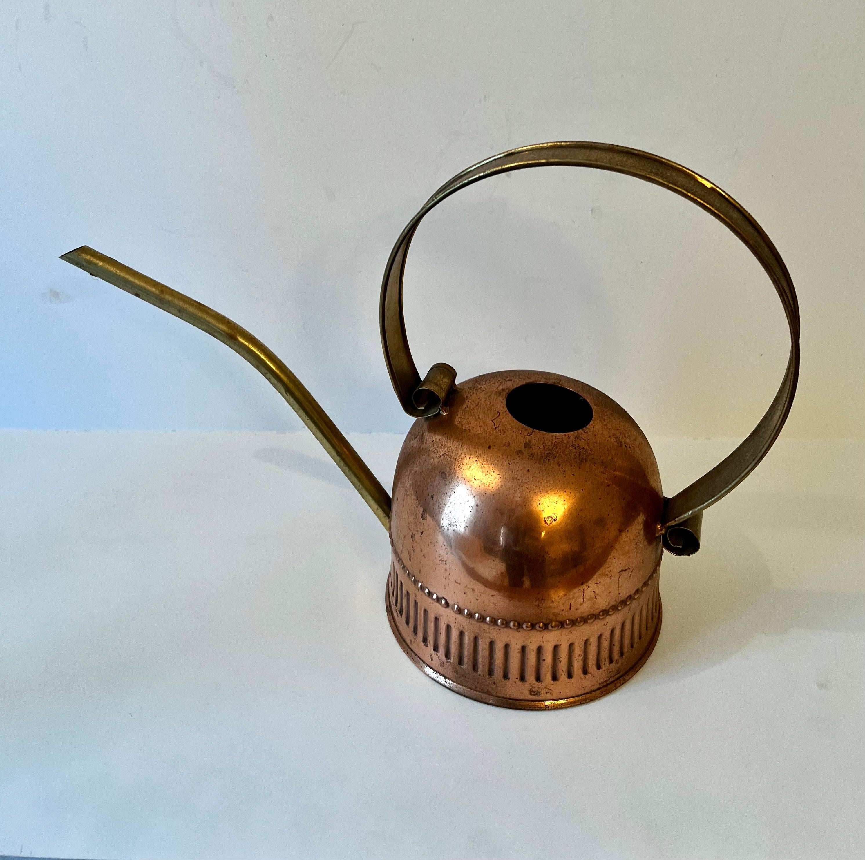 A lovely brass and copper watering can - perfectly suited for watering inside plants or smaller outside plants and a compliment as a decorative piece, in the house or on the patio.