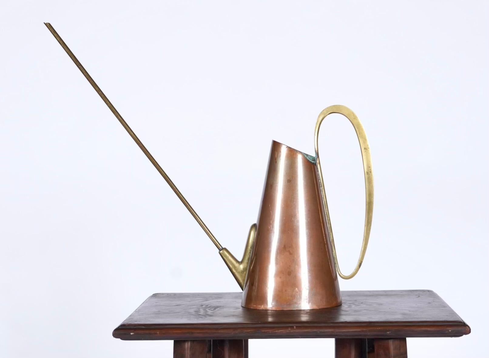 Brass and copper watering can sold by Illums Bolighus of Denmark. With a long narrow spout for the delicate watering of plants. During the 1950s African violets were very popular in many parts of Europe and it was important not to get the leaves wet