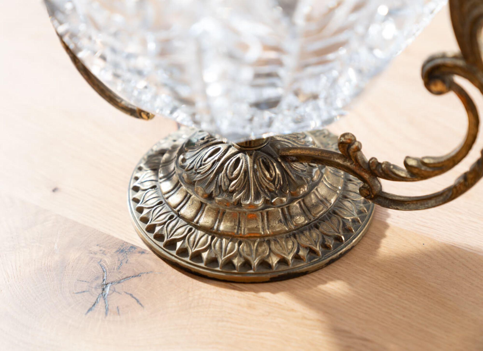 Brass and Crystal Centerpiece Vase - 1950s
Add a touch of vintage elegance to your home with this stunning brass and crystal centerpiece vase from the 1950s.

Crafted in Italy with high-quality materials, this vase features a classic and timeless
