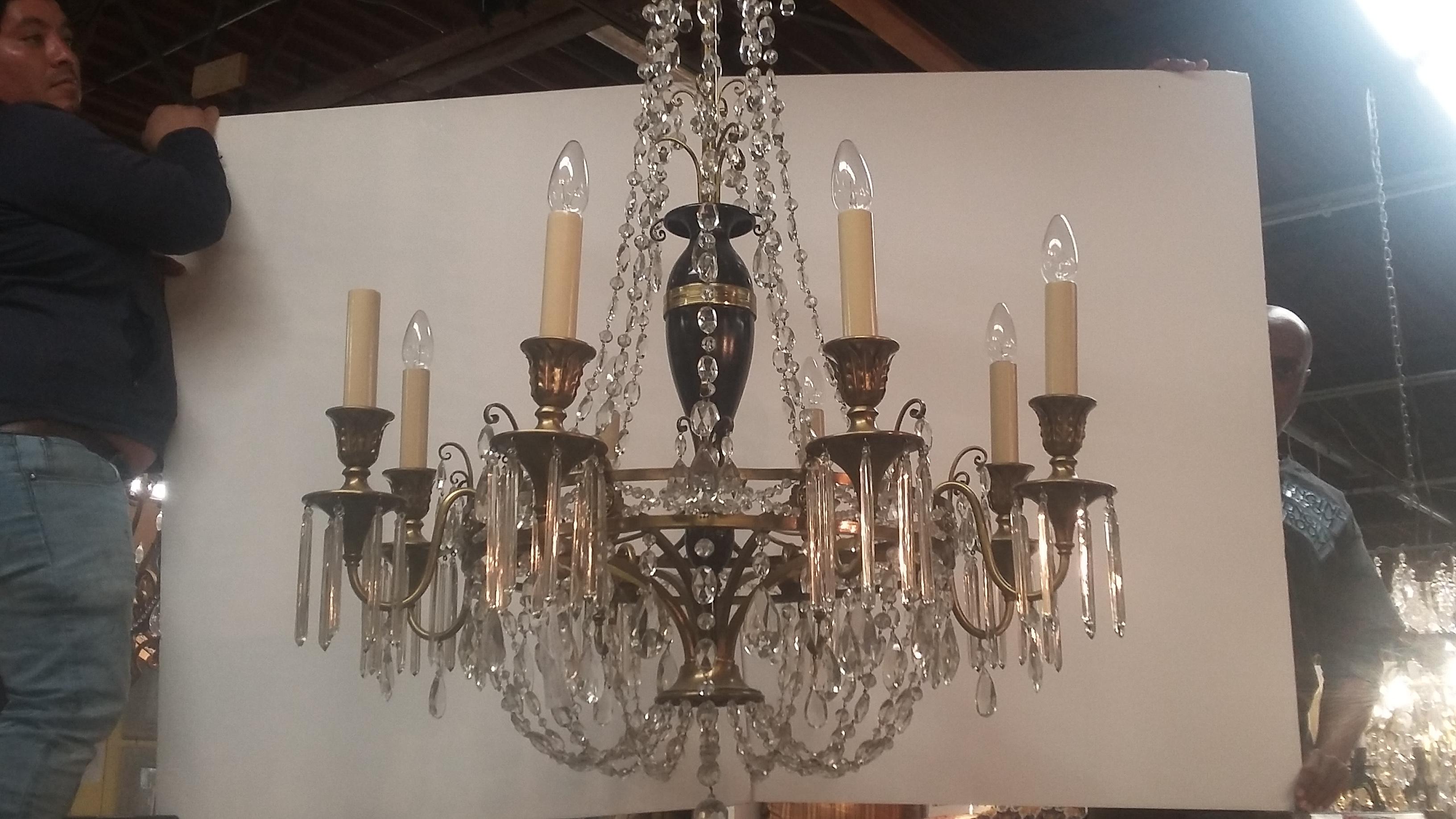This 8 light brass and crystal chandelier has been cleaned and rewired. Satin finish on the brass is very nice. Various sized crystals throughout the chandelier. Estimated as early 20th century. Originally salvaged from a Greenwich, CT estate.