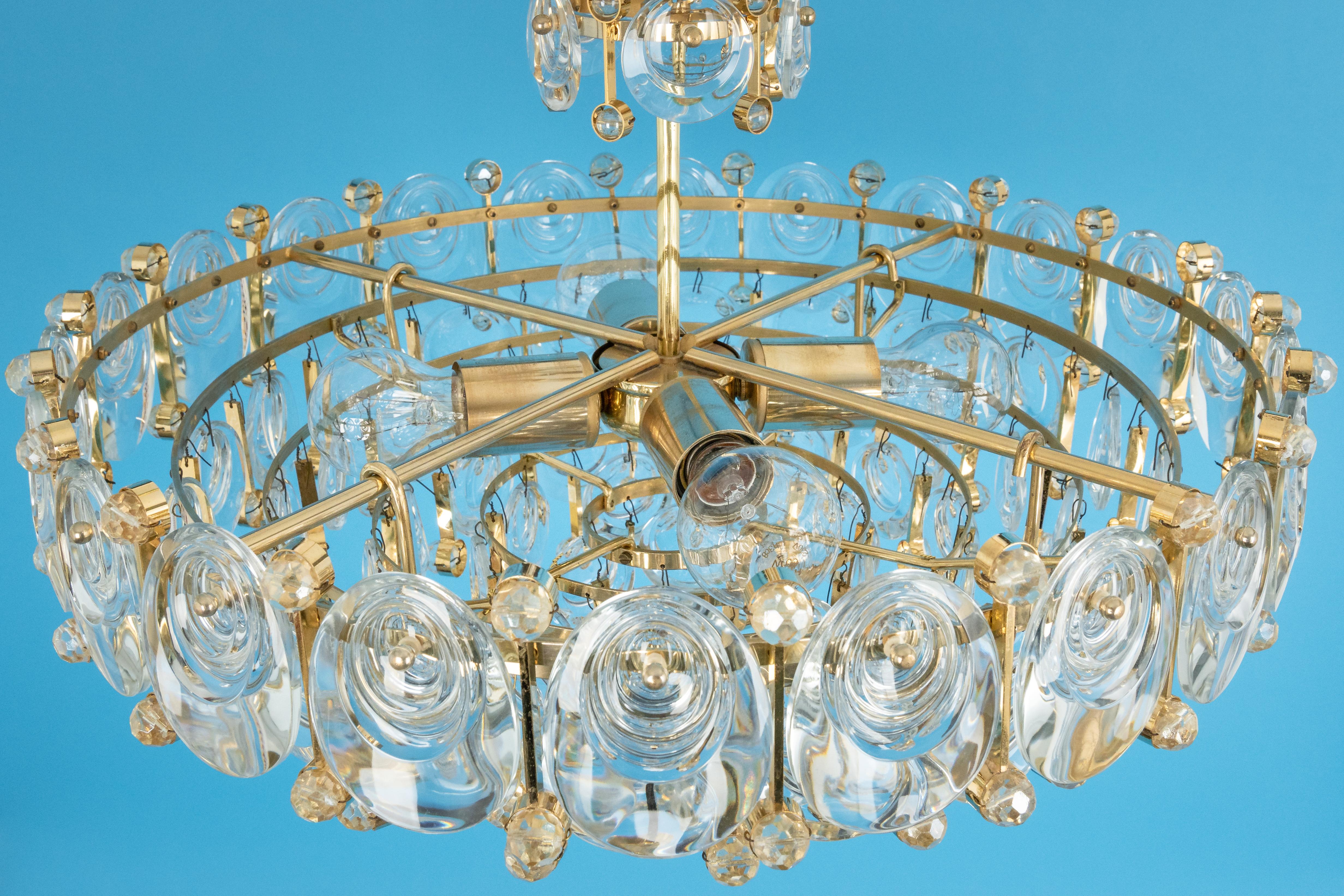 A wonderful and high-quality gilded chandelier or pendant light fixture by Palwa -Design Sciolari, Germany, 1970s.
It is made of a 24-carat gold-plated brass frame decorated with individual 