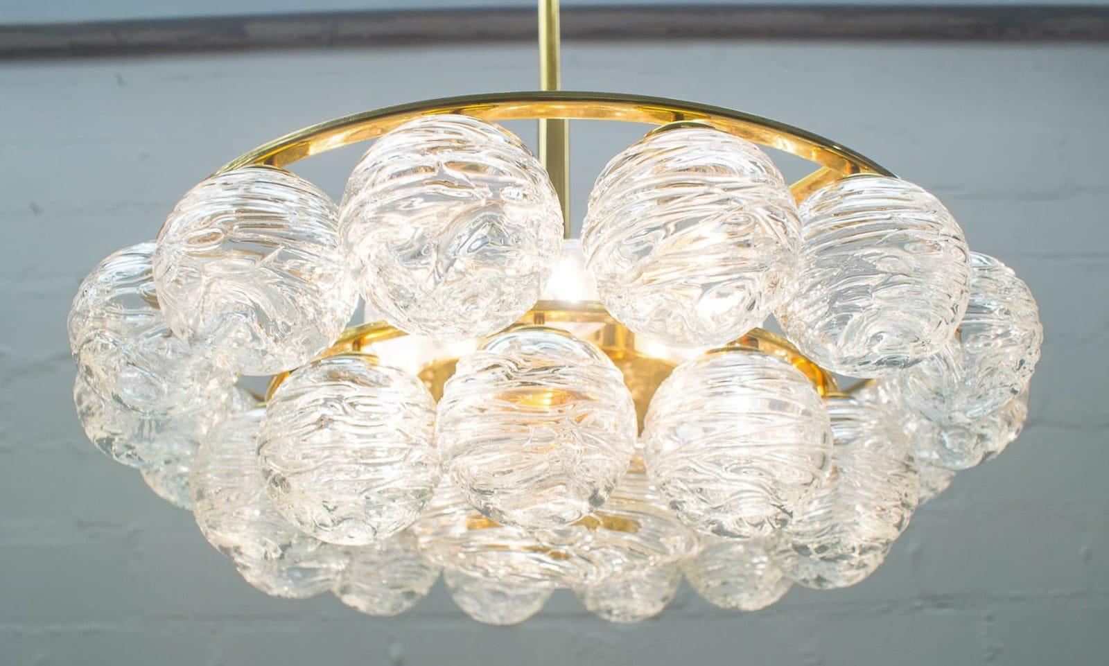 This chandelier features eight E14 sockets and 27 glass globes. Made in Fürth, near Nuremberg in Germany in the 1960s.

 