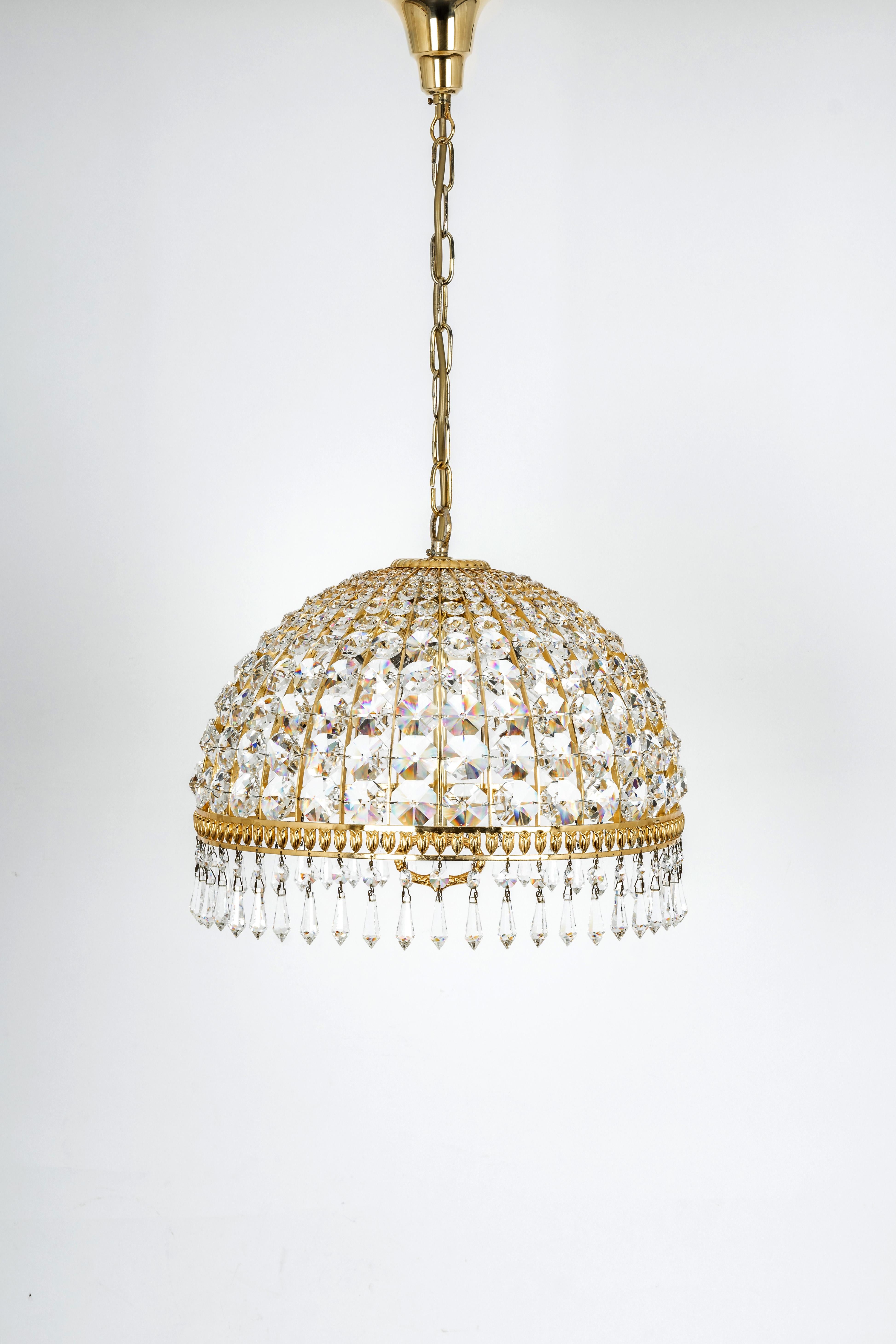 A wonderful and high-quality brass chandelier by Palwa, Germany, 1970s.
It is made of a brass frame and many crystals. Great scale and exquisite detail.

The lamp takes 6 x E14 (small Bulbs up to 40 Watts each)
Light bulbs are not included. It