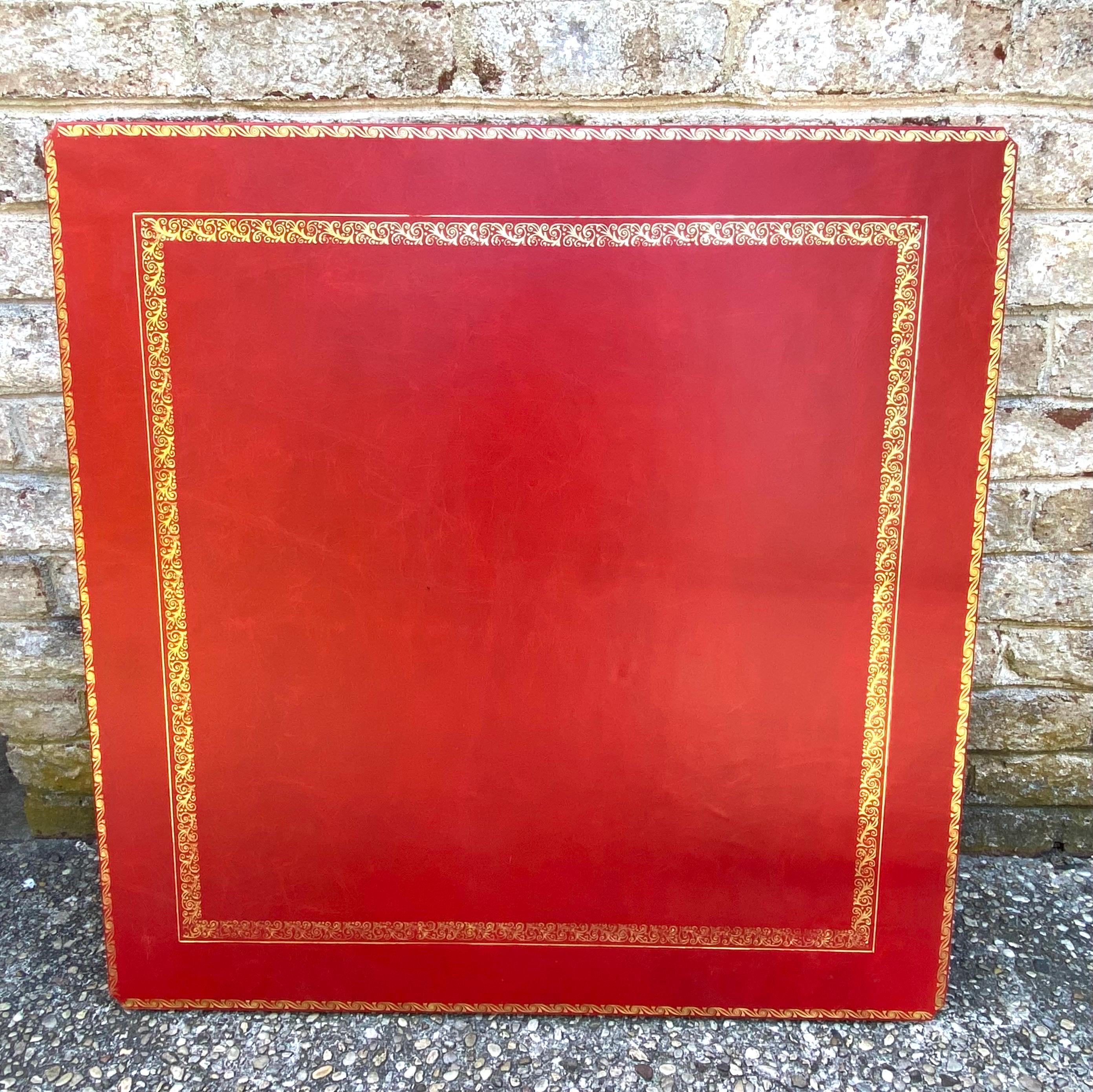 Stunning embossed red leather and brass two tiered coffee table.