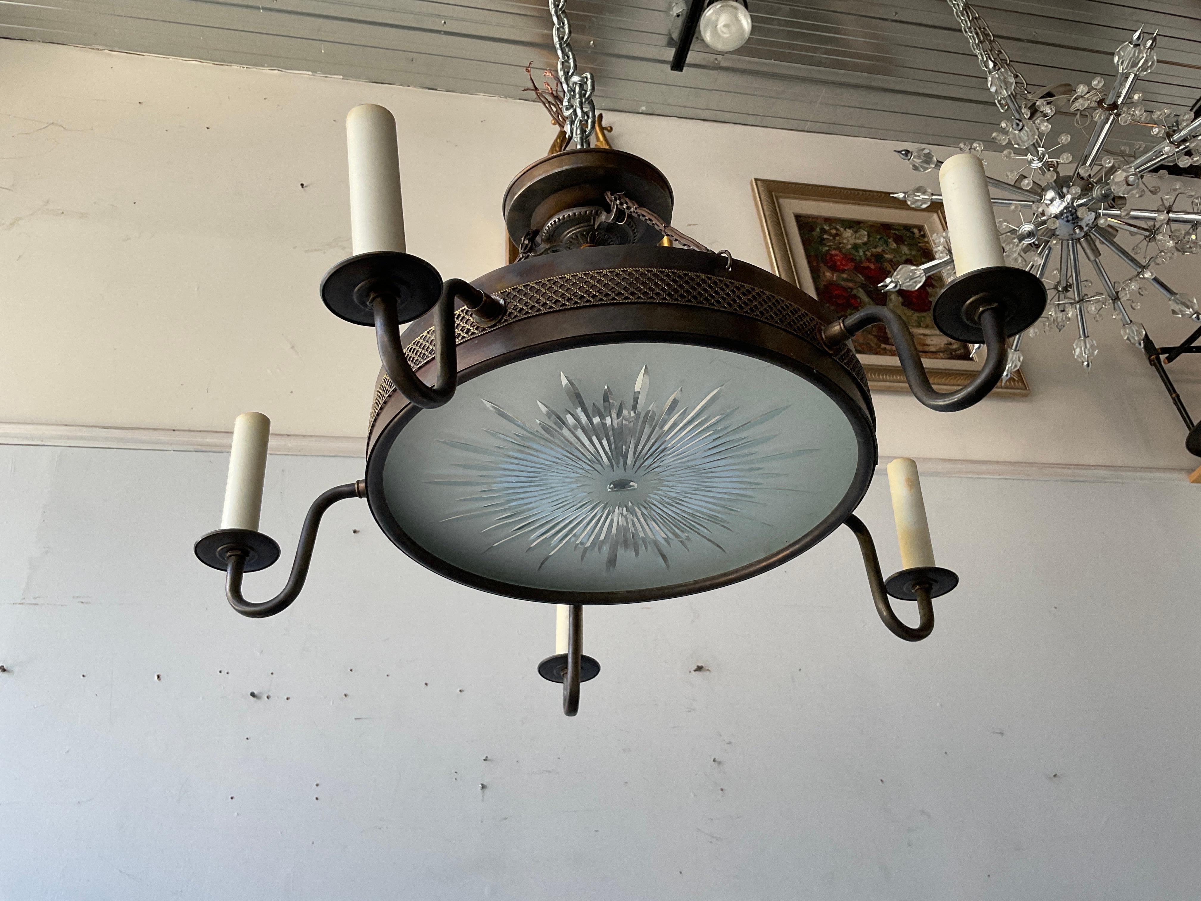 Brass Regency style chandelier with starburst glass bottom.
Needs rewiring.
