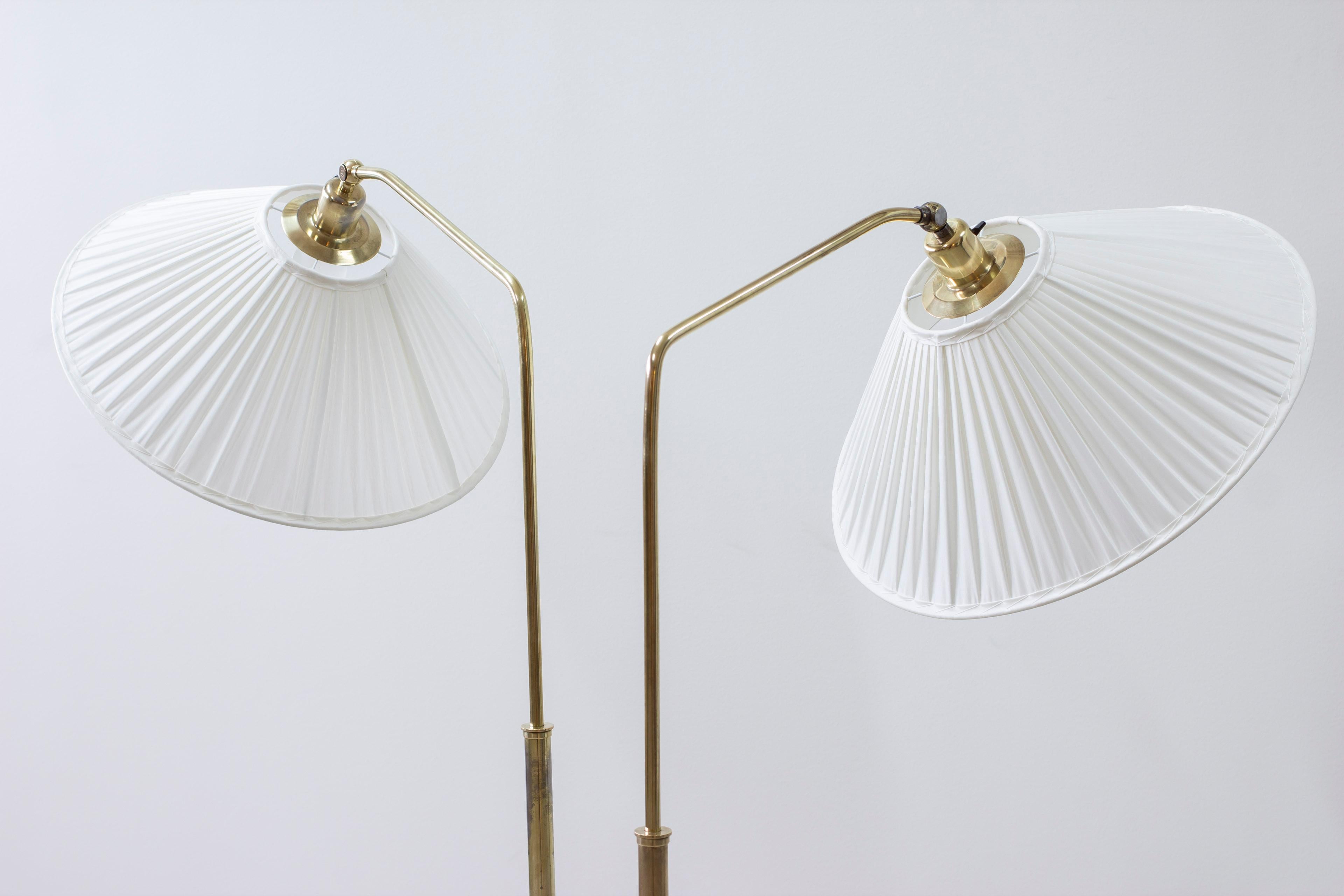 Mid-20th Century Brass and fabric floor lamps by Harald Elof Notini, Böhlmarks, 1940s For Sale