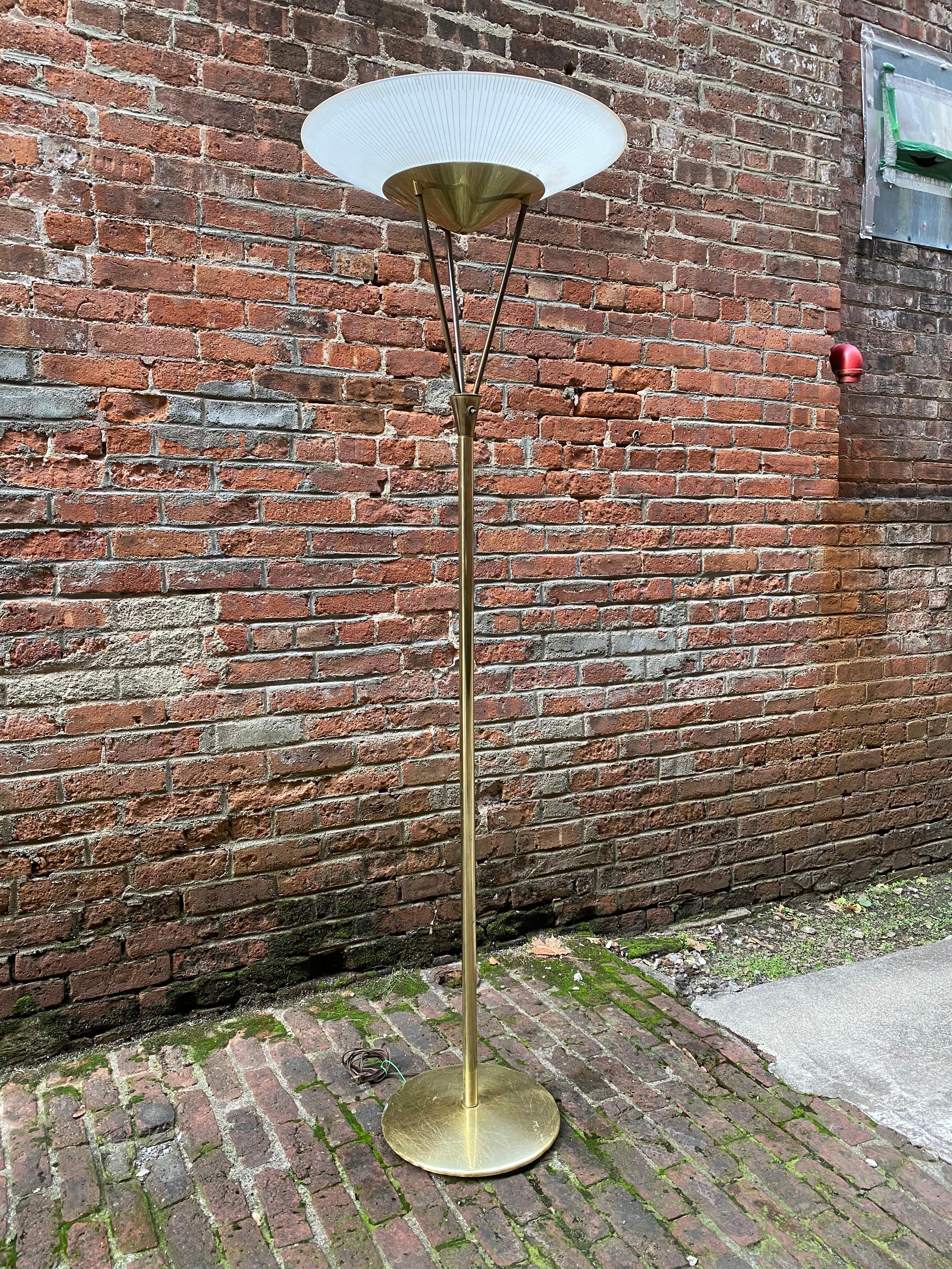 Frosted glass and brass torchère style floor lamp. Original working wiring, circa 1950-1960. The lamp sends off a warm upward radiant glow. 

Condition is fair with scratches on the base, minor finish loss and a few very minor chips to the