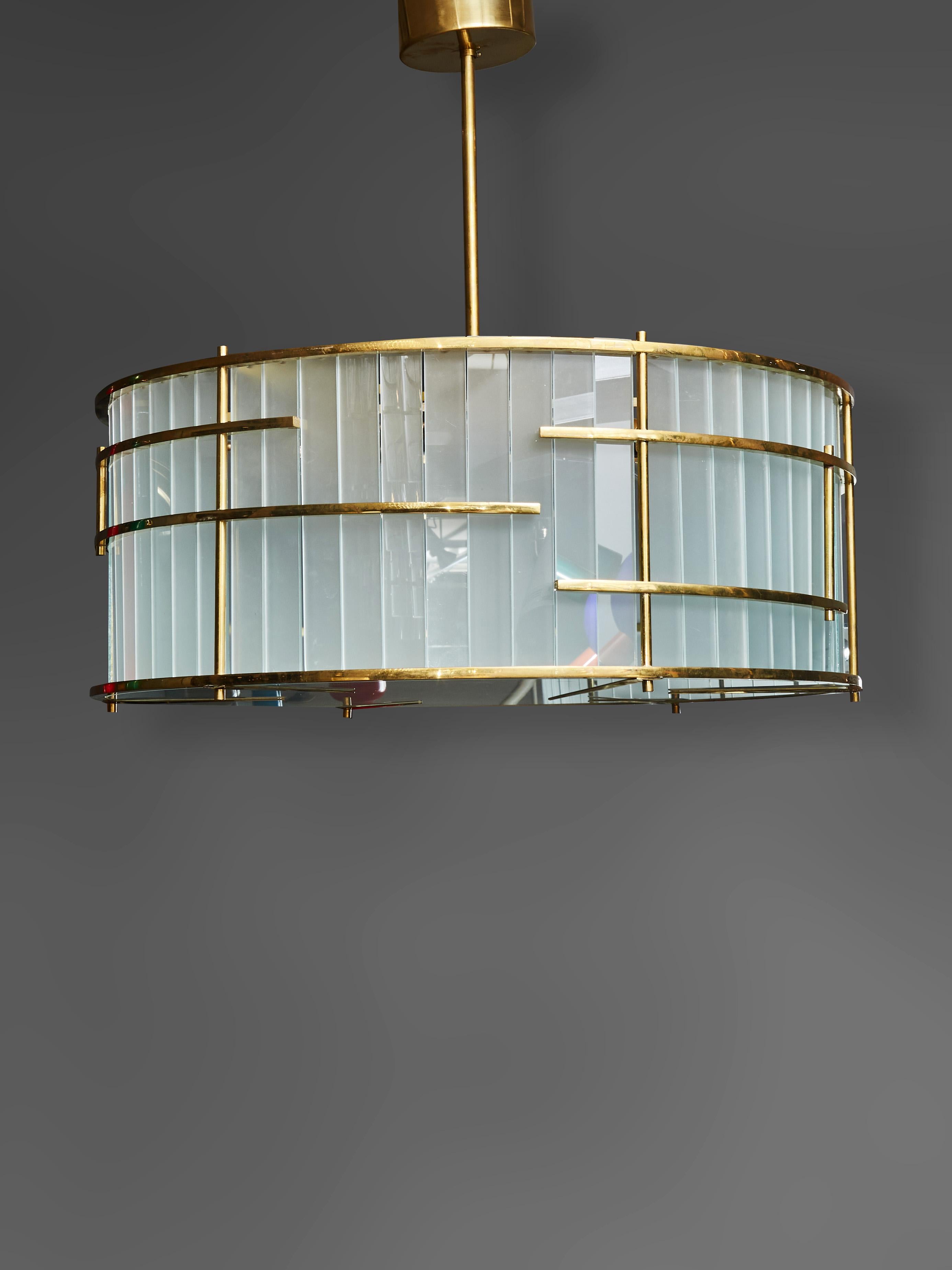 Round chandelier made of a brass structure and slabs of frosted Murano glass.