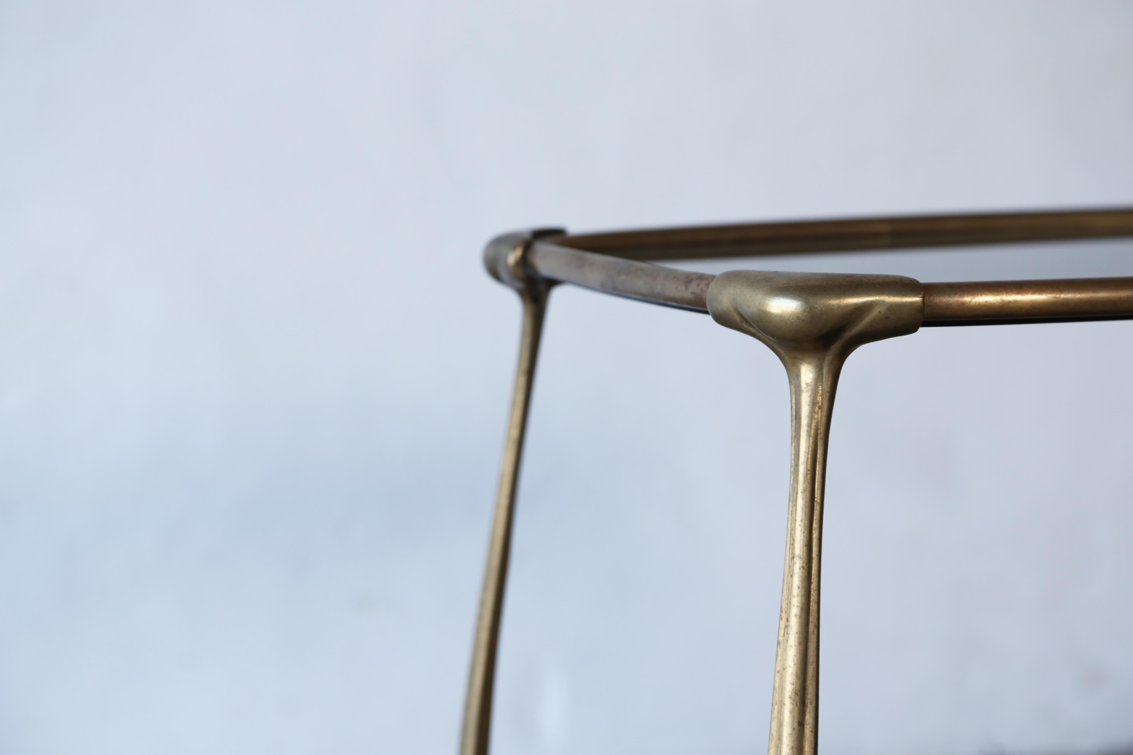 An elegant brass and glass bar / side table, France, 1950s.  In good original condition with some signs of use and wear relative to age.   Fast shipping worldwide.


