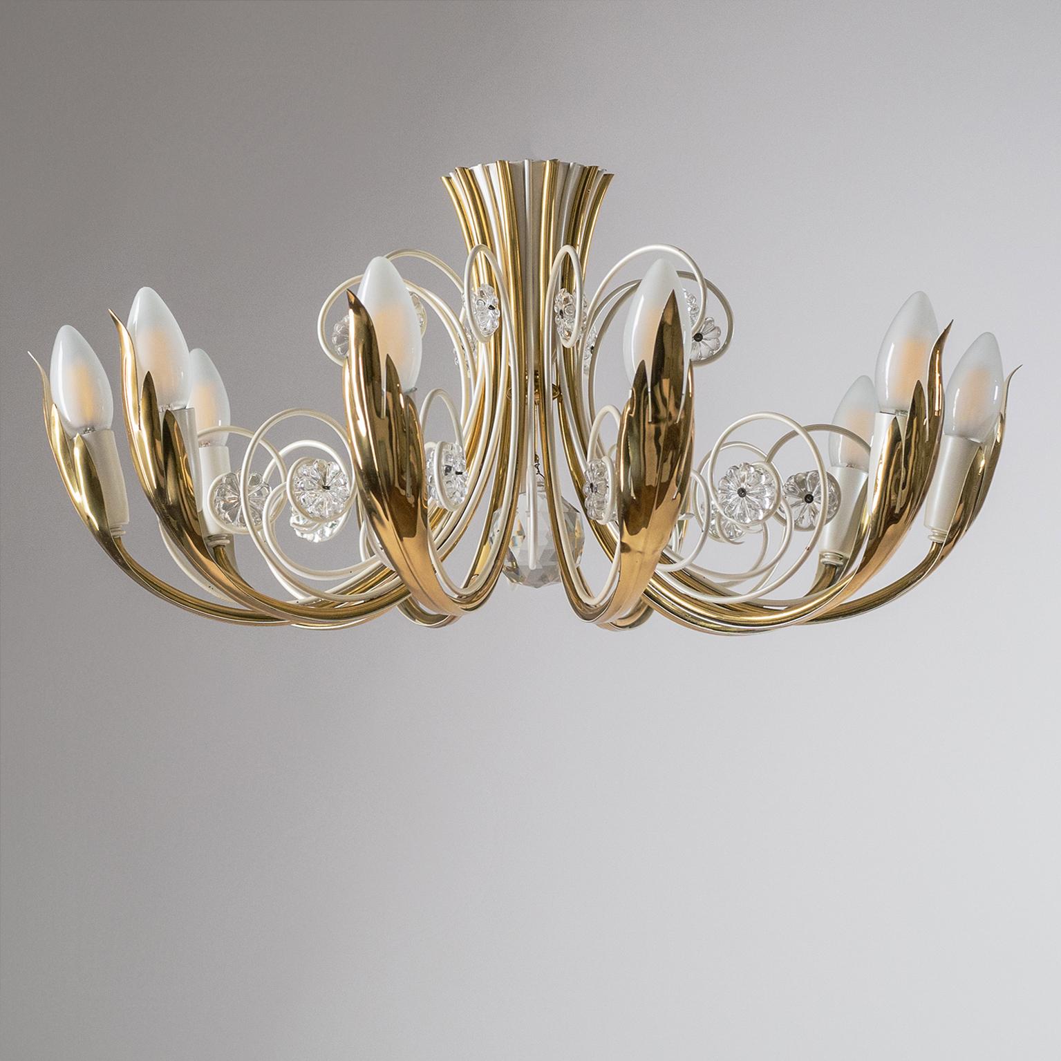 Rare ten-arm semi-flush mount by Vereinigte Werkstätten from the early 1960s. Ten brass arms each morphing into a stylized floral element cradling the socket cover and bulb. In between are pearly-white lacquered elements with glass flowers and a