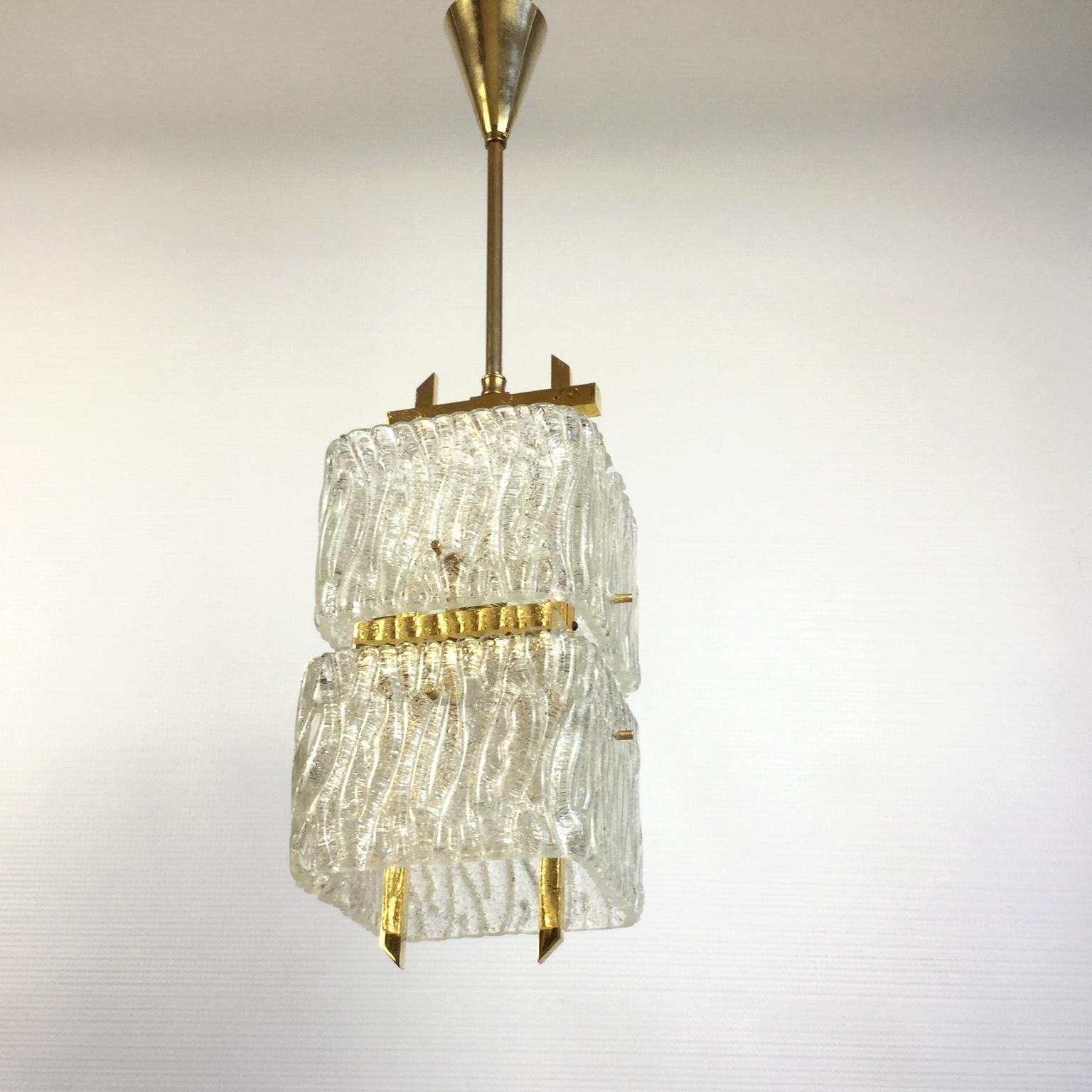 Chandelier with 2 thick glass shades in the shape of a square wavy ribbon fixed on a brass frame
Completely rewired.