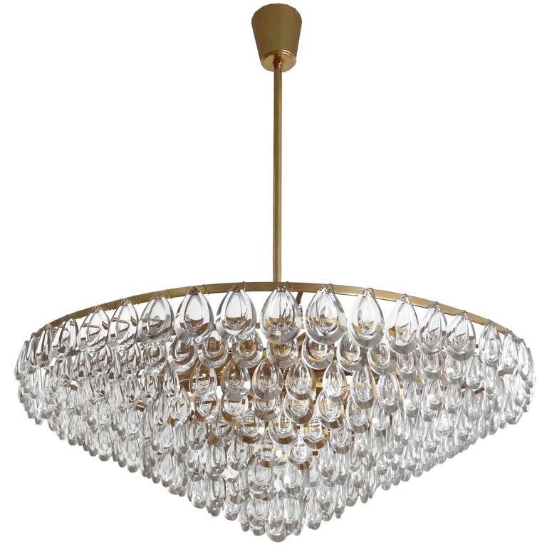 A chandelier consisting of multiple pieces of teardrop glass hung on a brass frame by Palwa.

German, Circa 1960's

In stock.

UL Listing Service available upon request.