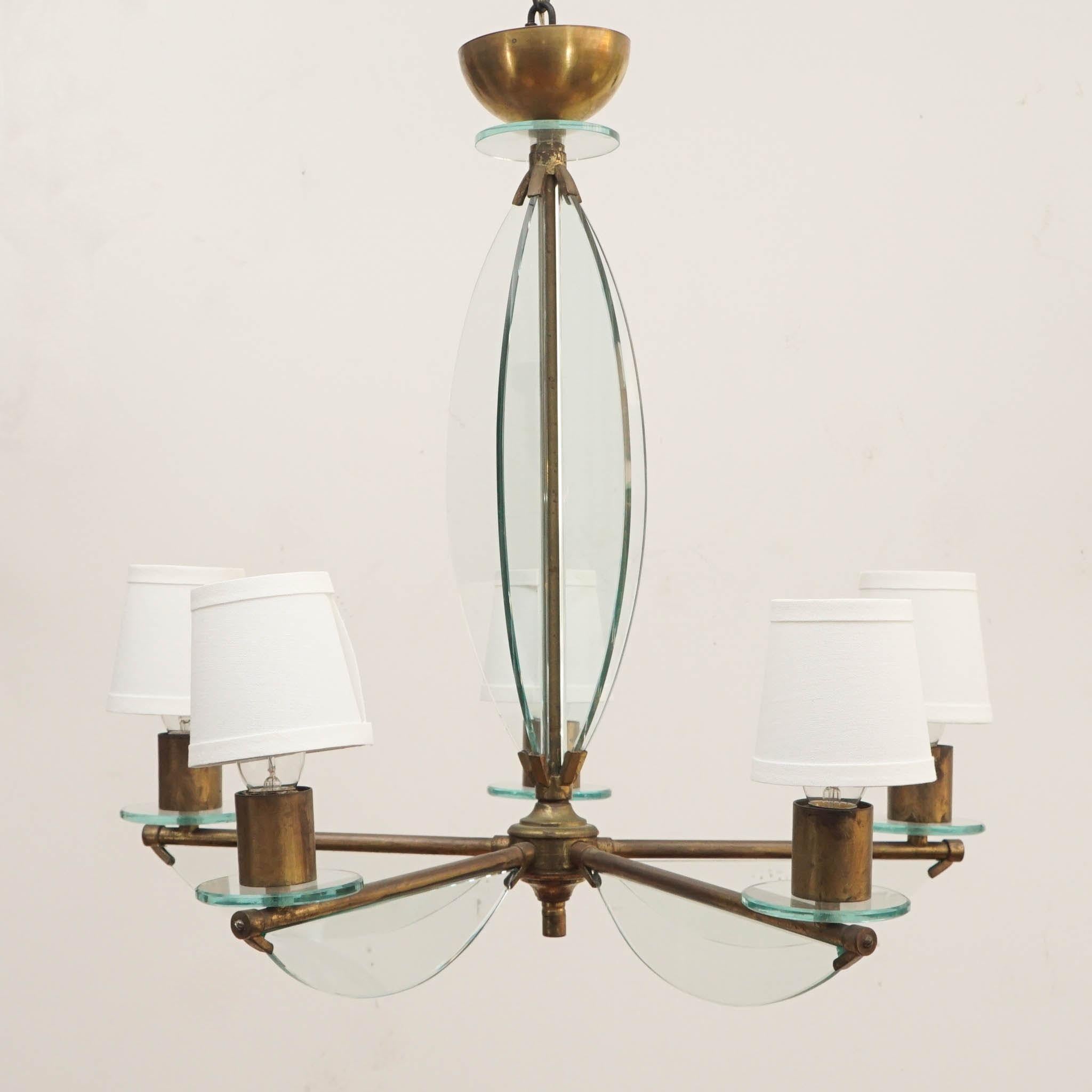 Inspired by the timeless elegance of Fontana Arte designs, this antique brass and glass chandelier exudes a refined simplicity that is sure to elevate any space. The classic combination of brass and glass creates a sophisticated and luxurious