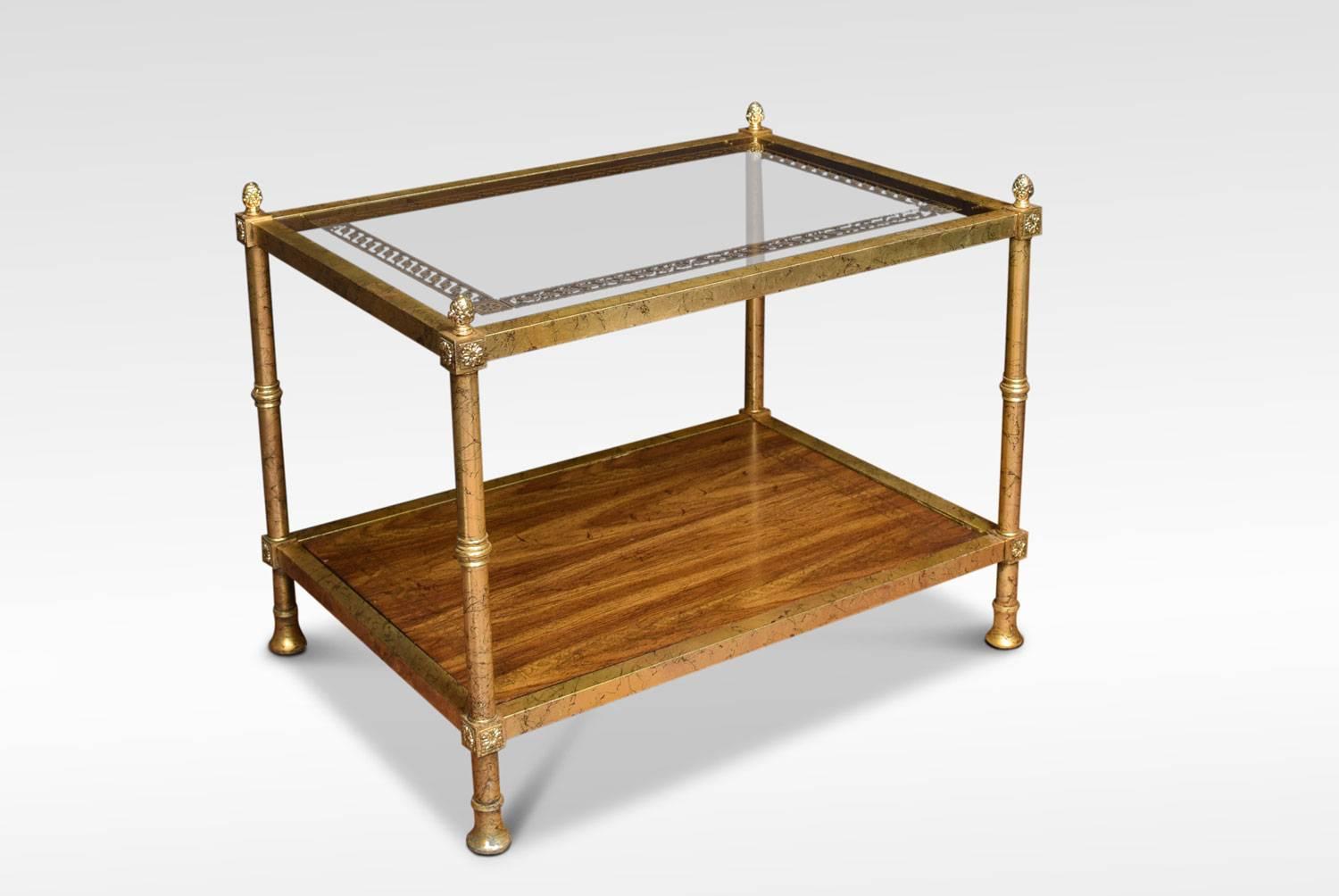A brass and glass coffee table in the manner of Maison Jansen, with glass top with scrolling gilded decoration. Set within a brass frame, the legs headed by acorn finials and join by under-tier.
Dimensions:
Height 22.5 inches
Width 28.5