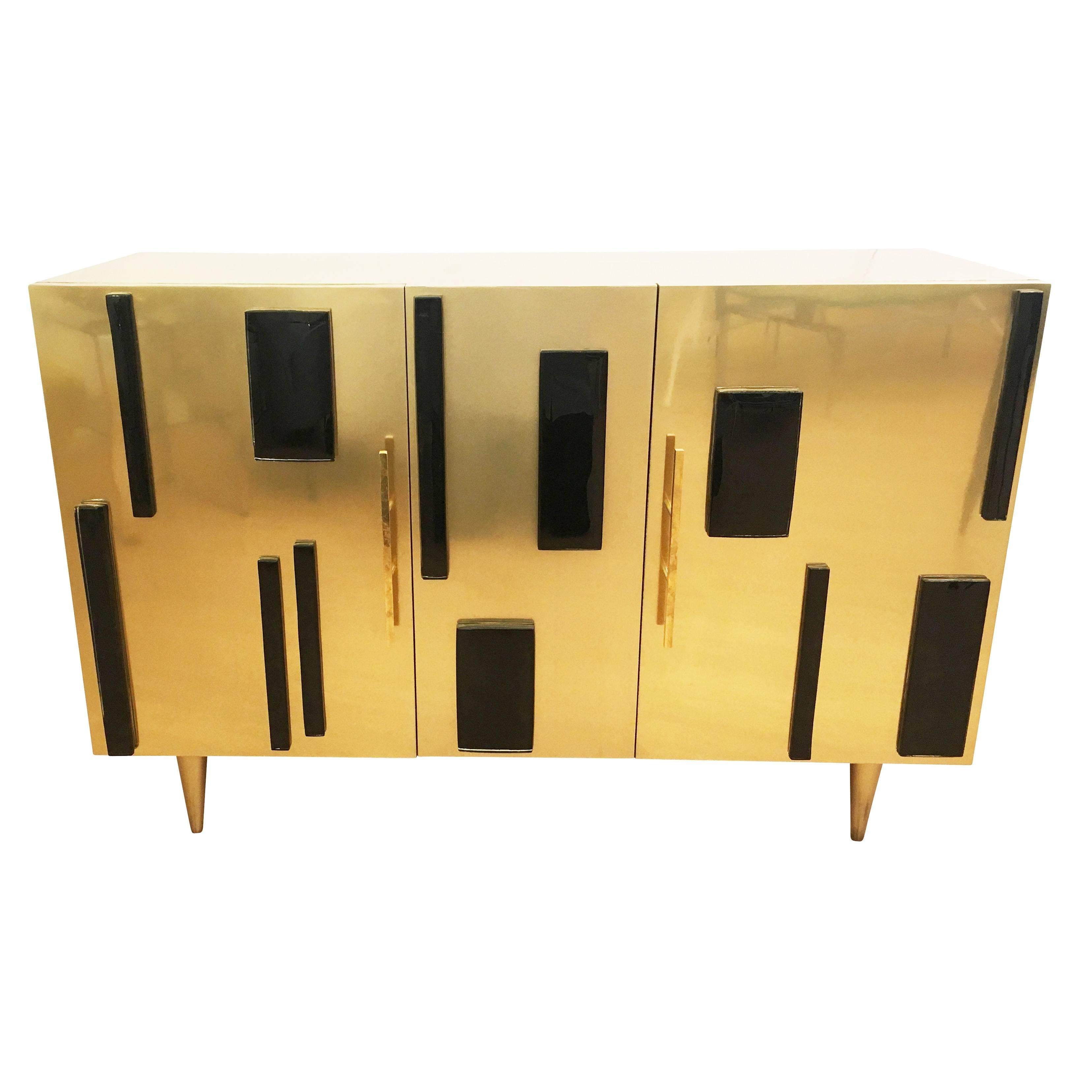 Limited edition credenza made by Italian artisan furniture maker, Interno 43 exclusively for Gaspare Asaro’s, studio line, formA. Paneled in brass and decorated with black glass. This is a special price for the last floor model-Original price was