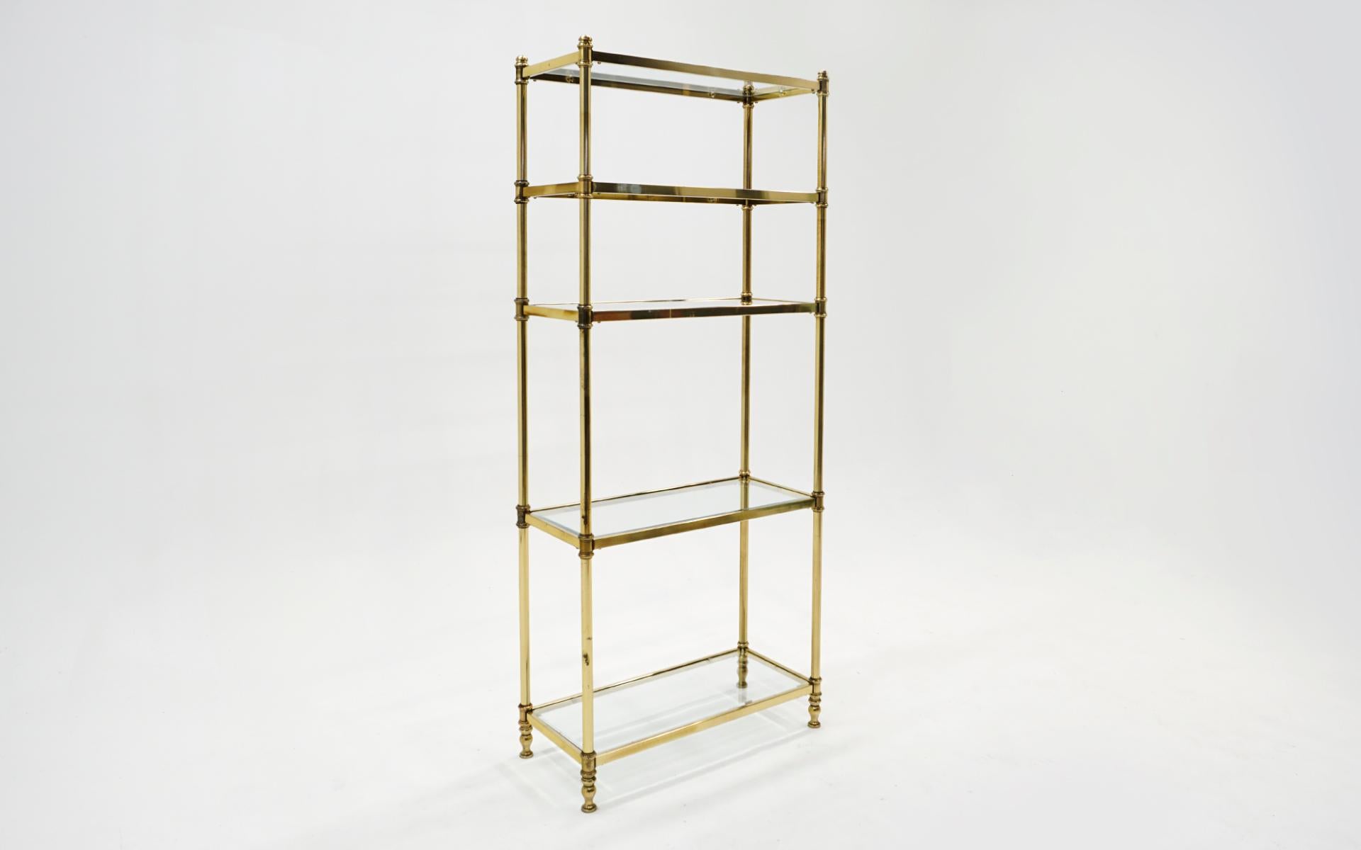Brass and glass etagere / storage / display shelves. Signs of wear and loss of brass finish. Overall a very nice vintage appearance.