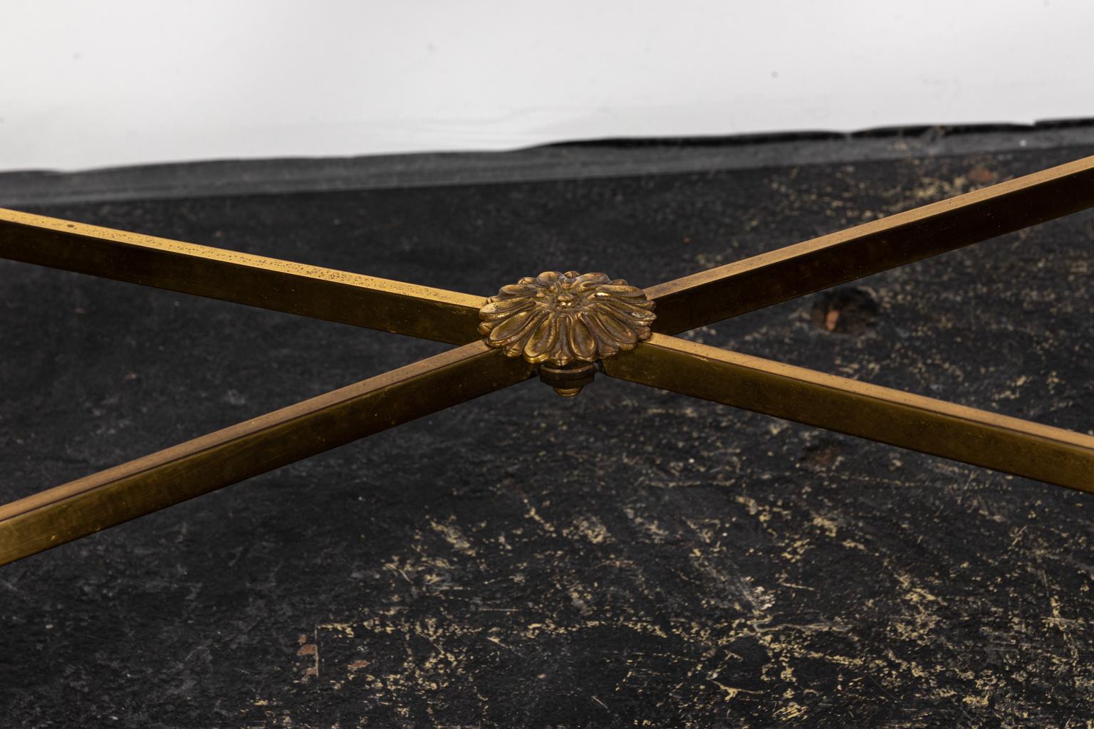 Brass and glass etched coffee table with foliage trim on the table top and X-shaped cross stretcher. Please note of wear consistent with age including minor paint loss.