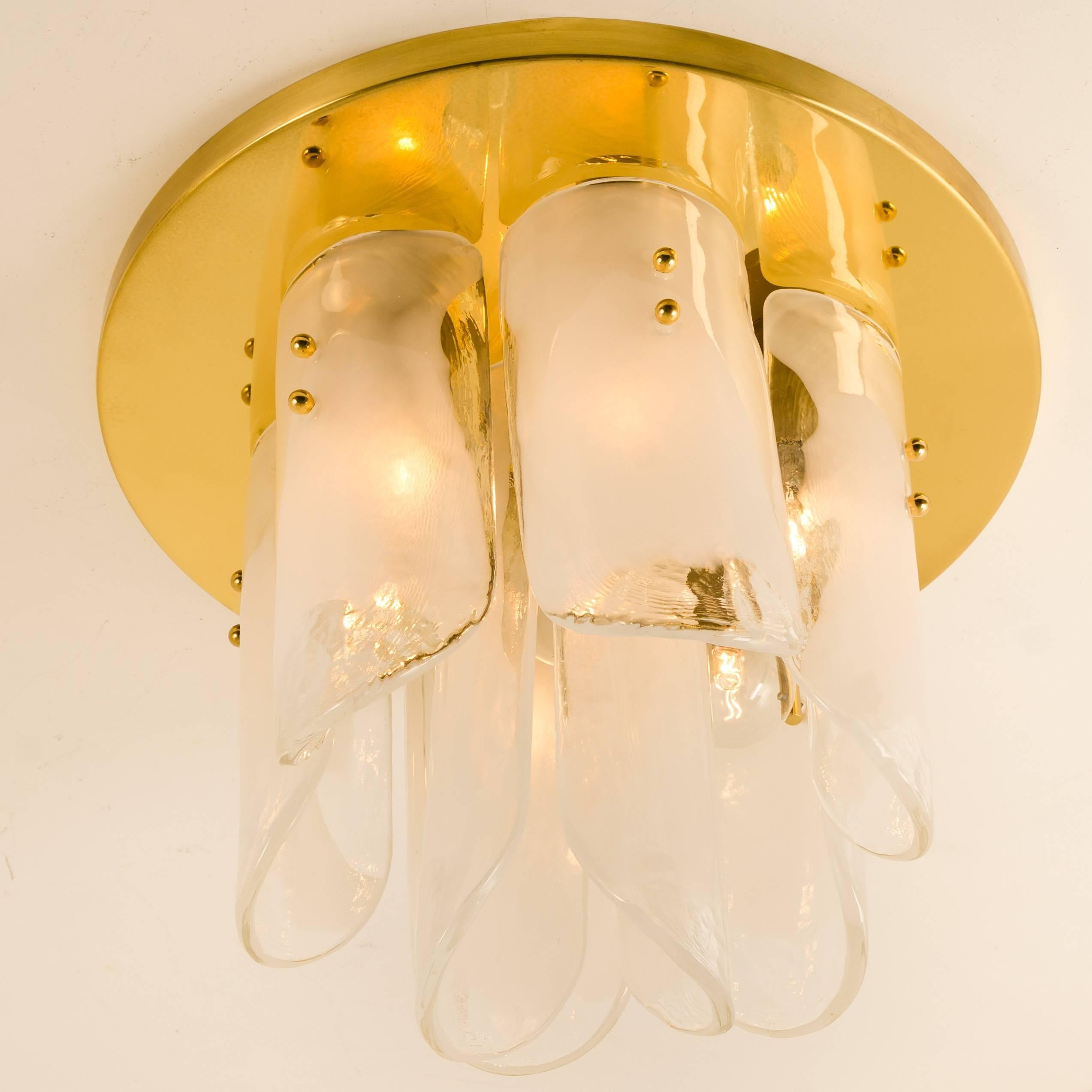 A high quality brass flush mount with beautiful thick textured hand blown white and clear melting glass panels. Mounted on a polished solid brass flush mount and held in place by rounded brass screws. Designed and executed by Kalmar Vienna in the