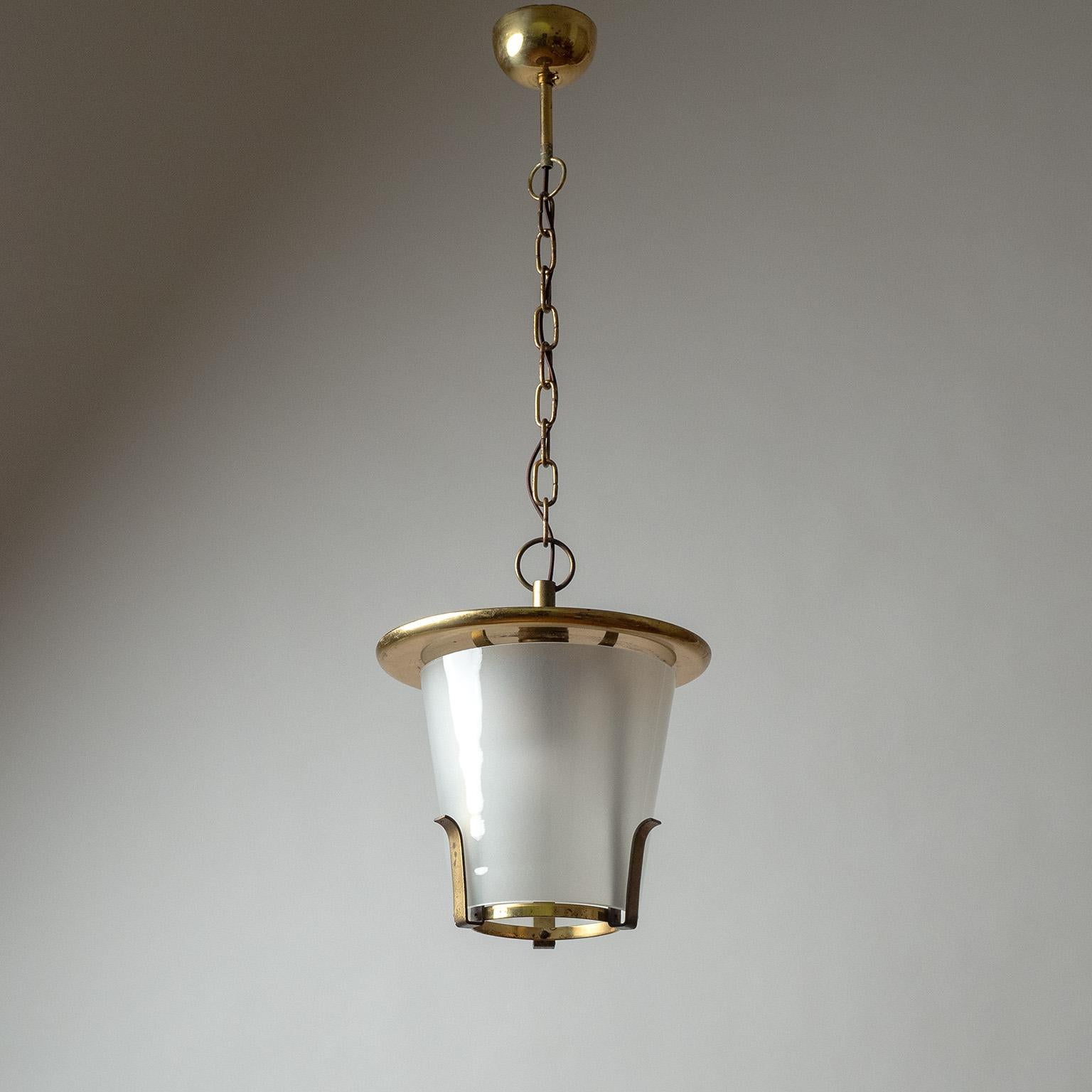 Sublime Art Deco (with a Bauhaus influence) brass and glass lantern from the 1930s. Minimalist brass hardware with a conical blown glass diffuser (frosted on the inside), which is suspended by three brass 'clips'. Very nice original condition with