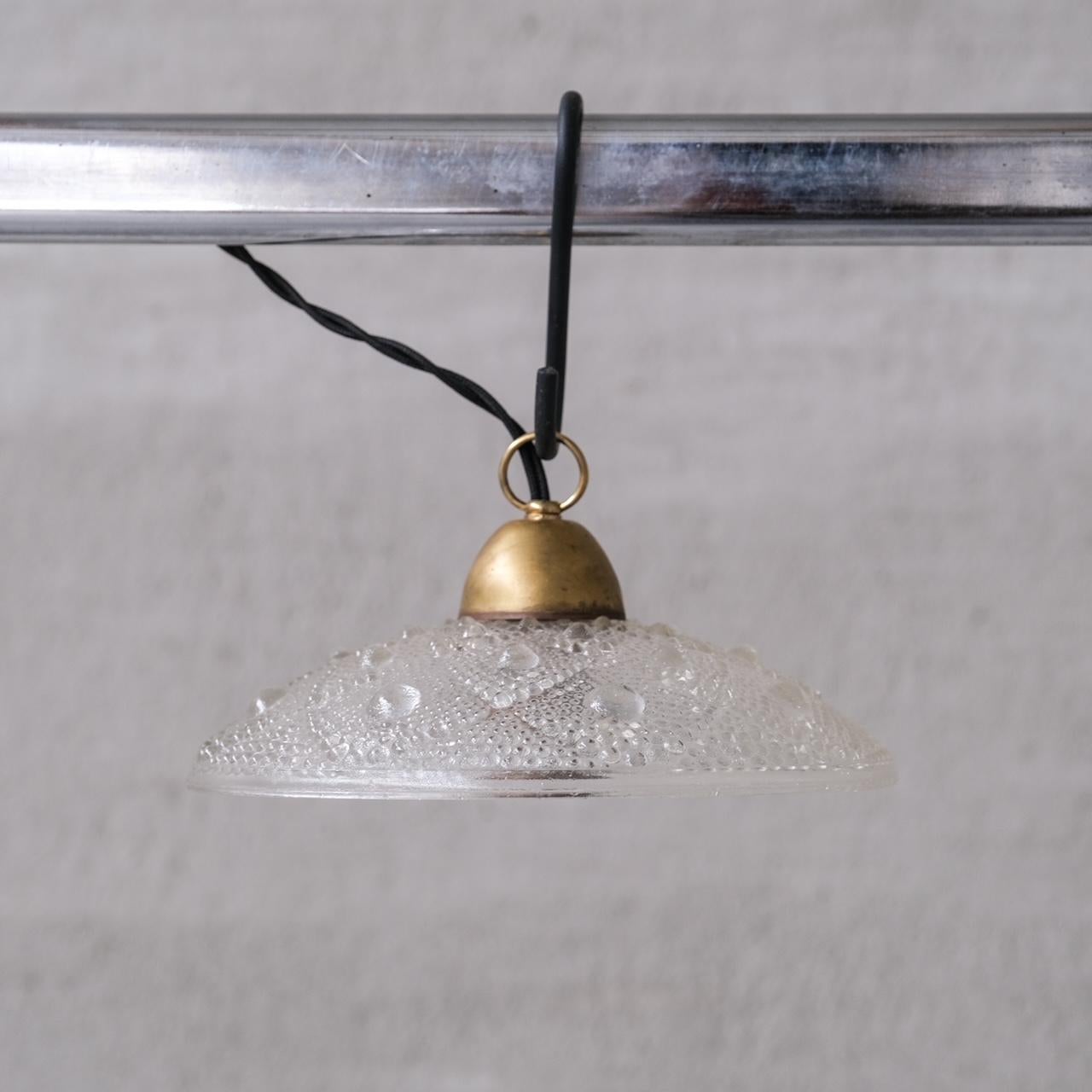 Unusual glass and brass shade pendant lights.

France, c1960s.

Patterned glass with raised 'bubbles'. In a 'mandala' esque pattern.

PRICED AND SOLD INDIVIDUALLY. 7 AVAILABLE AT THE TIME OF LISTING.

No chain or ceiling rose was retained, we can