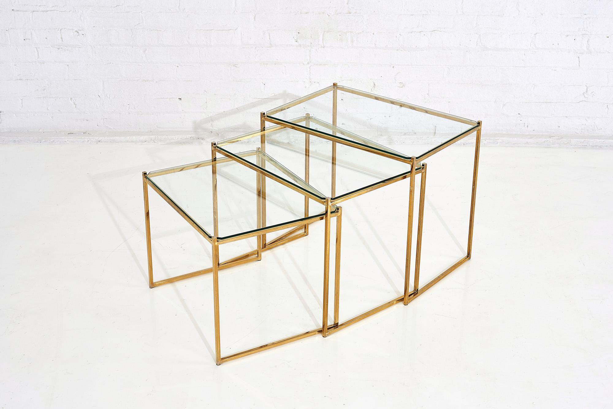 Brass and glass nesting tables by Guy Lefevre for Maison Jansen, 1970’s. Set tables were designed by Guy Lefevre during the 1970’s, for Maison Jansen in France.