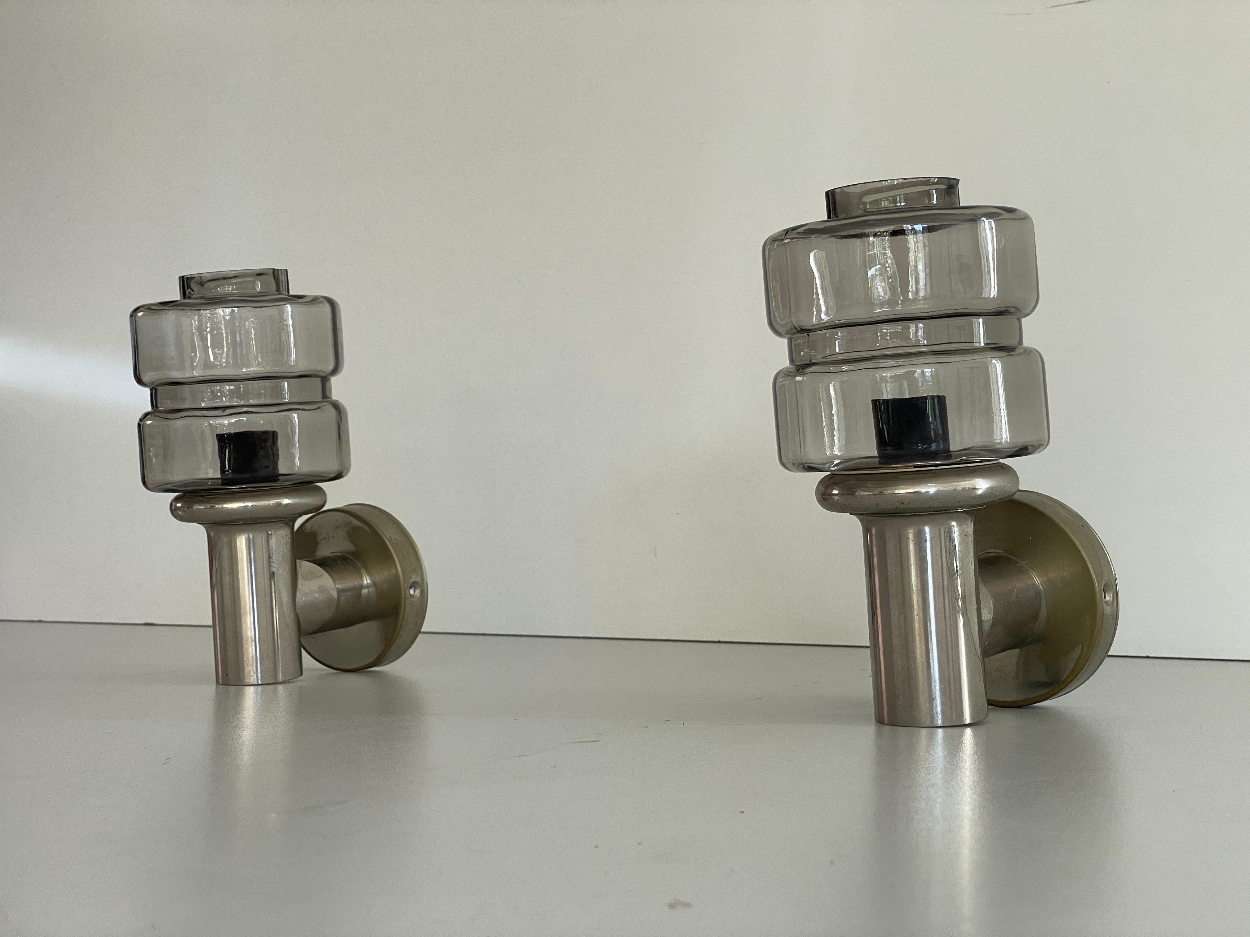 Brass and Glass Pair of Sconces by N Leuchten, 1960s, Germany

Elegant rare high quality wall lamps.

Lamps are in very good vintage condition.
Wear consistent with age and use

These lamps works with E14 standard light bulbs. 
Wired and suitable to