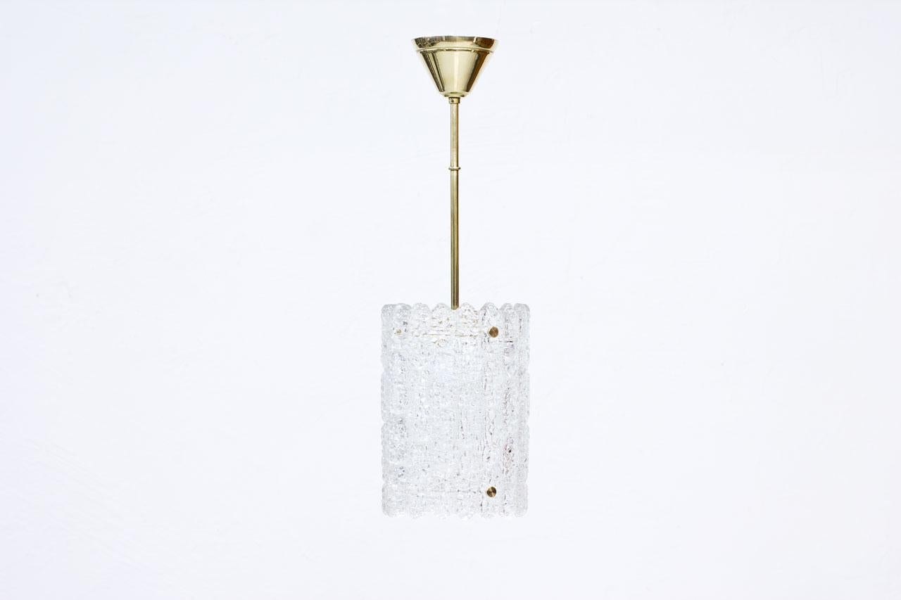Ceiling lamp designed by Carl Fagerlund, manufactured by Orrefors in Sweden during the 1960s.
Brass structure with glass diffuser.