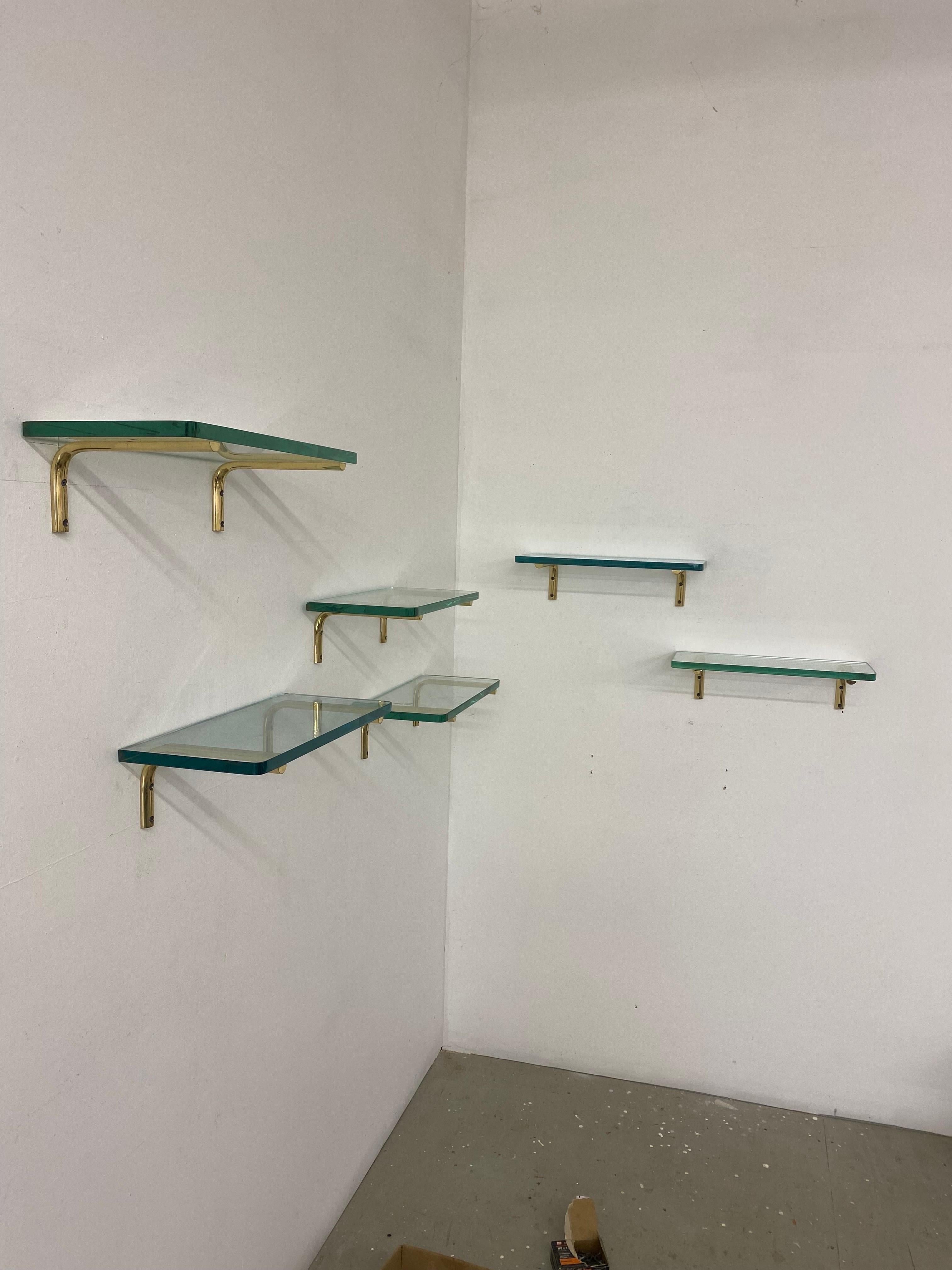 glass shelves with gold brackets