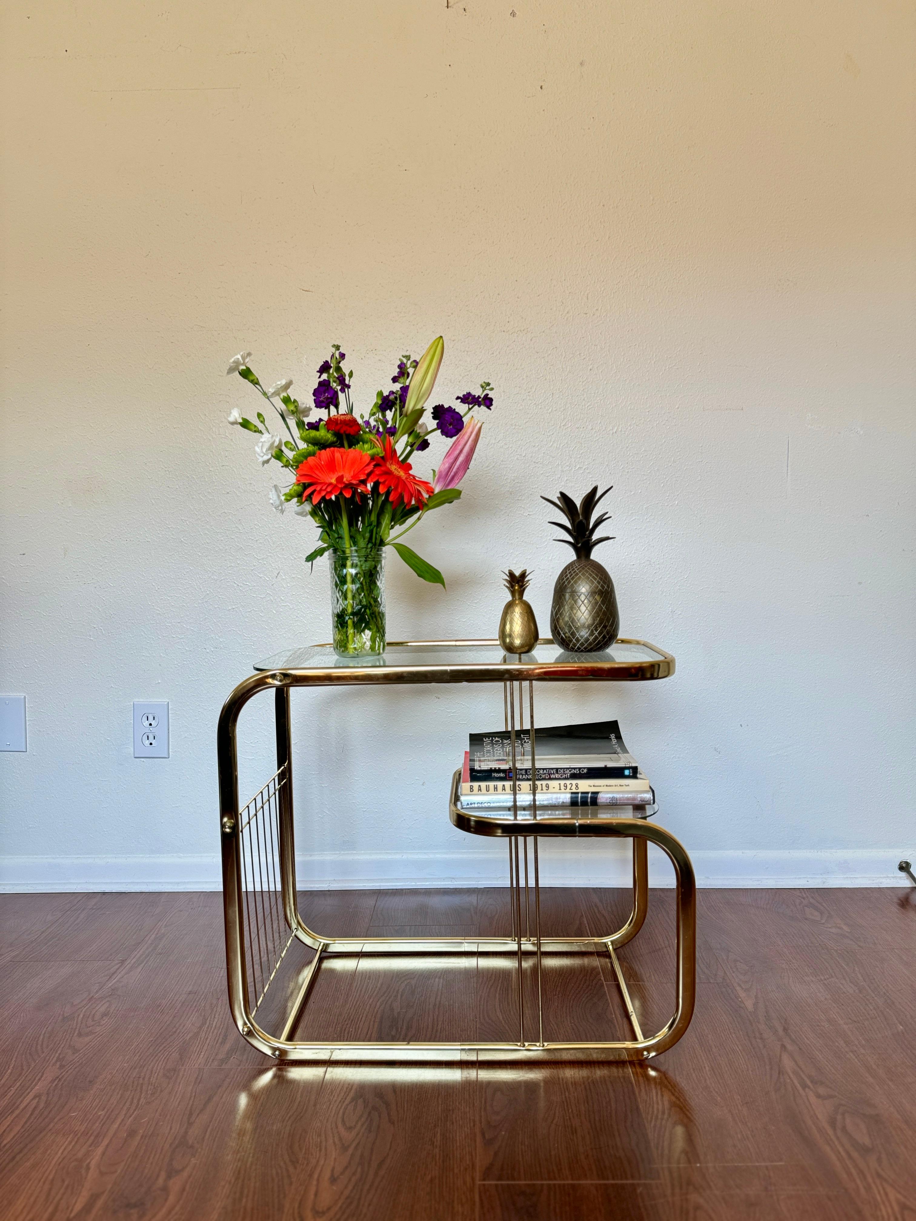 Brass and glass vintage bar cart in the style of Milo Baughman. Can also be used for books, plants, or whatever really! It makes any room look 100% more stylish. In good condition with no chips or cracks in the glass. 

20.5” H x 24” W x 12.5” D
