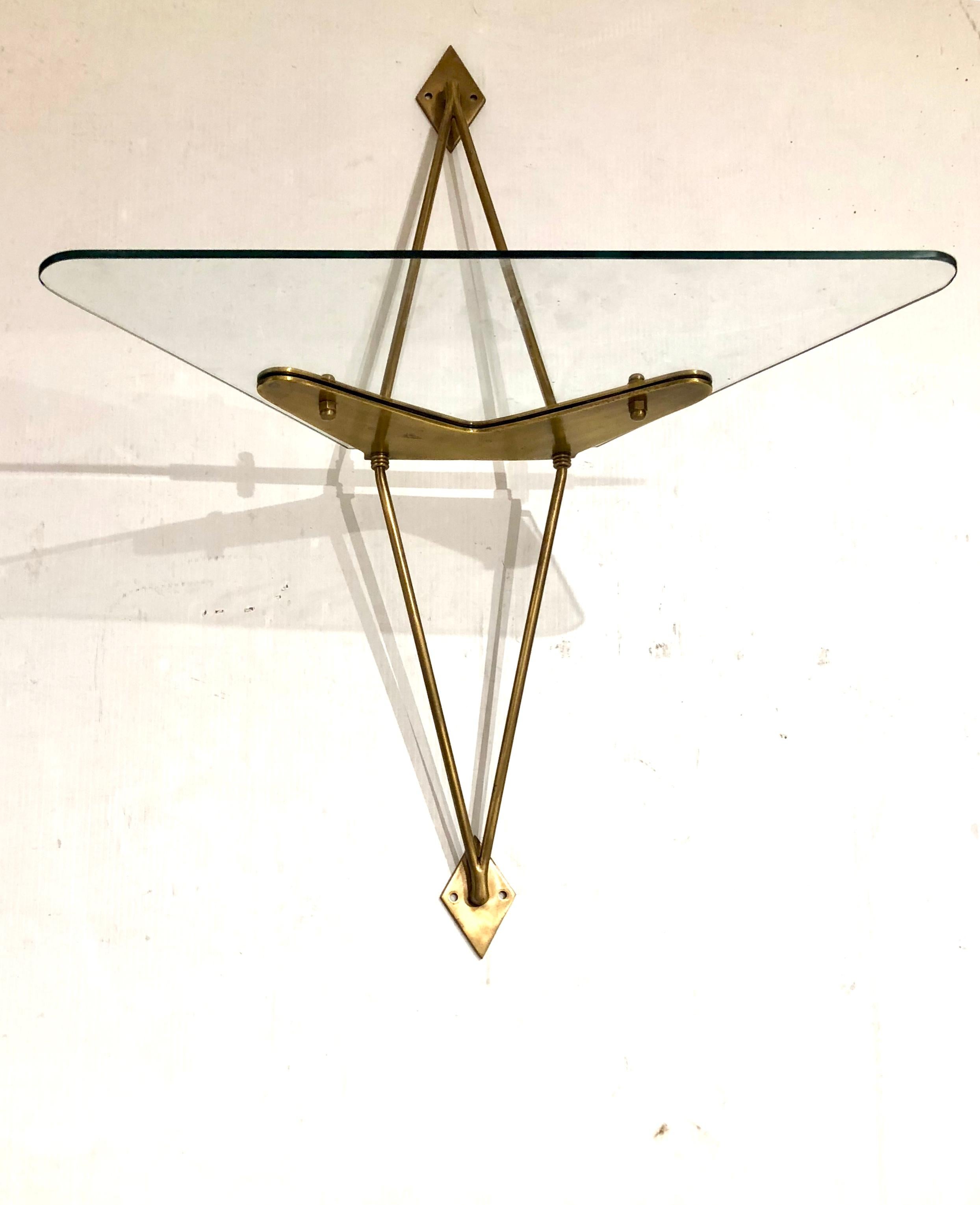 Brass and glass wall-mounted angle display shelf attributed to Fontana Arte, incredible and rare piece of solid brass and glass shelf, we believe its by Fontana Arte, circa 1950s in the style of Gio Ponti excellent condition no chips or cracks.