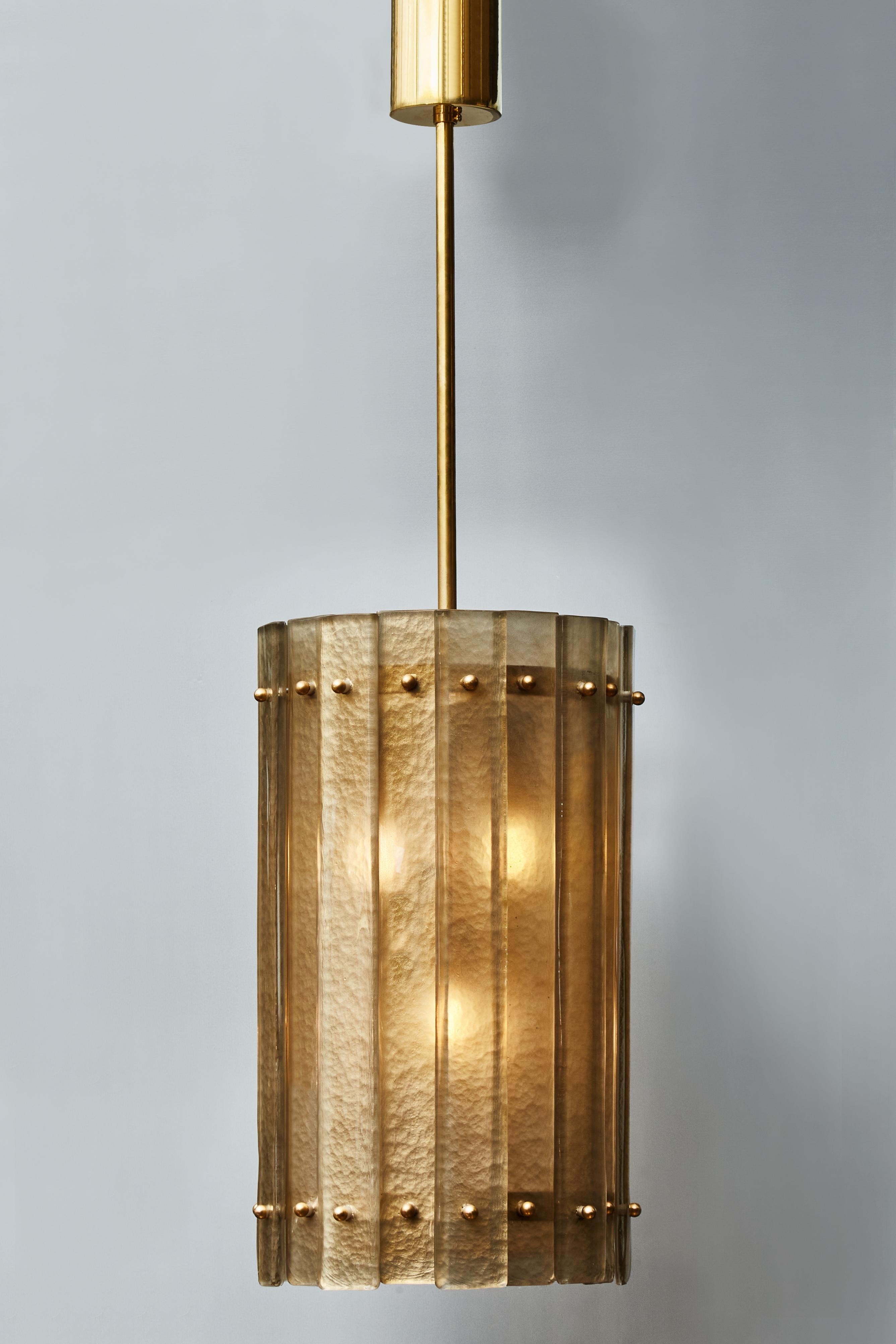 Circular brass lantern with golden smokey Murano glass slabs.

Price displayed per piece