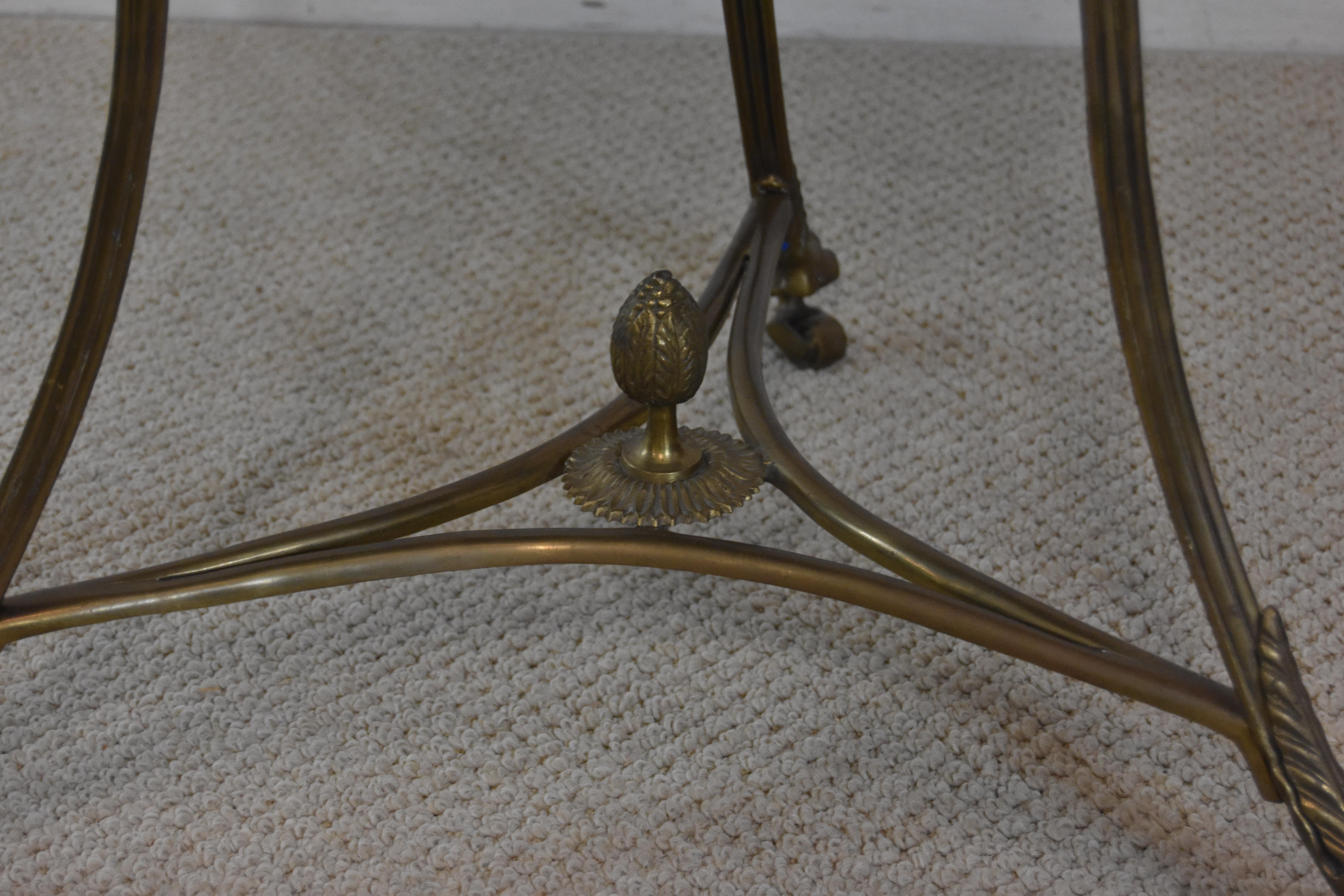 Brass framed round entry table with claw feet and centre finial. Granite top. Nice patina and overall very nice condition.