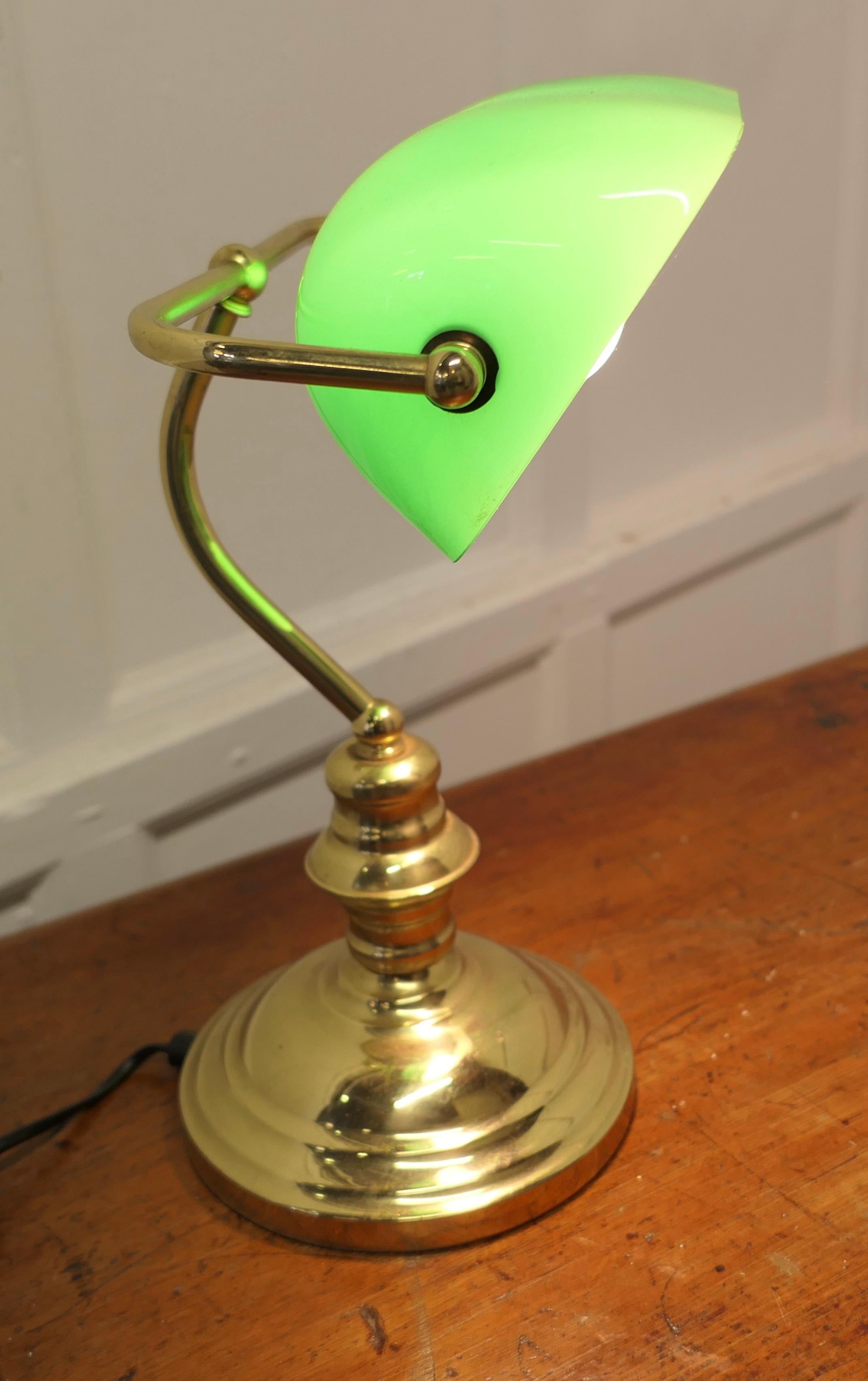 Brass and Green Glass Banker’s Desk Lamp

A beautiful quality fully adjustable early Banker or Barrister’s brass desk lamp, with a green glass lampshade which has a white reflective underside 
The Lamp is in good and working condition

The lamp is