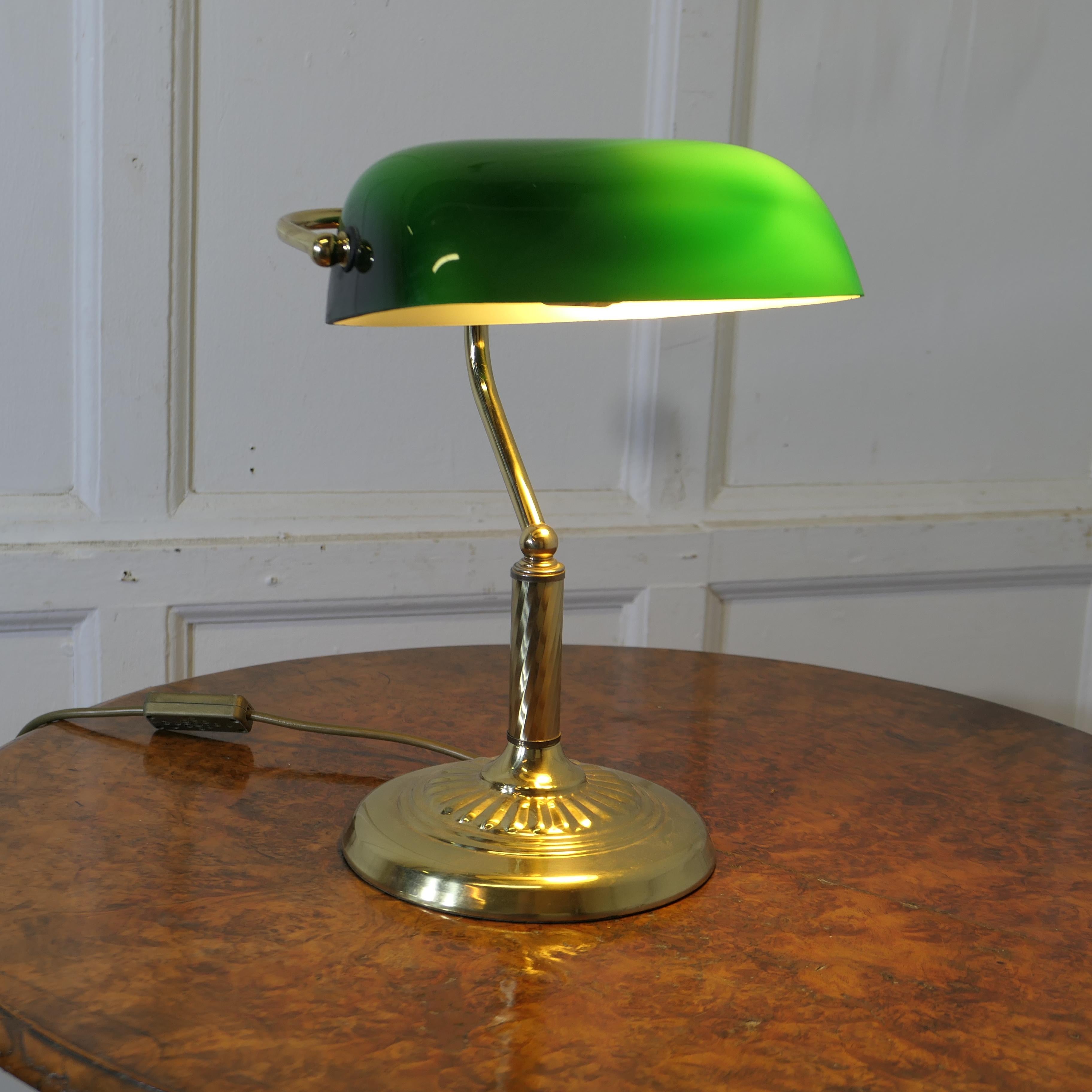 Brass and Green Glass Banker’s Desk Lamp

A beautiful vintage barrister’s brass desk lamp, with its original green glass lampshade which has a white reflective underside
The lamp shade can swivel up and down, it is in fine condition with an original