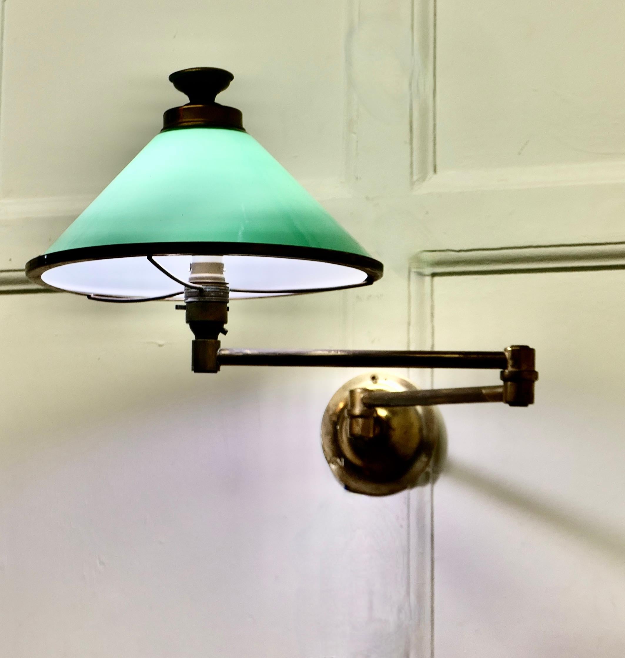 Brass and Green Glass Extending Wall Lamp
 
A lovely piece, the brass lamp comes with its original green glass shade
The lamp is fixed to the wall by a brass elbow bracket, allowing the lamp to be extended from side to side and back to front 
A