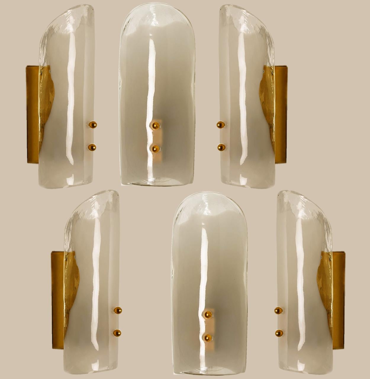 High-end wall sconces made of blown clear and opal Murano glass on a messing hardware. Designed and produced by J.T. Kalmar, Austria in the 1960s. Minimalistic design executed with a taste for excellence in craftsmanship. These are real statement