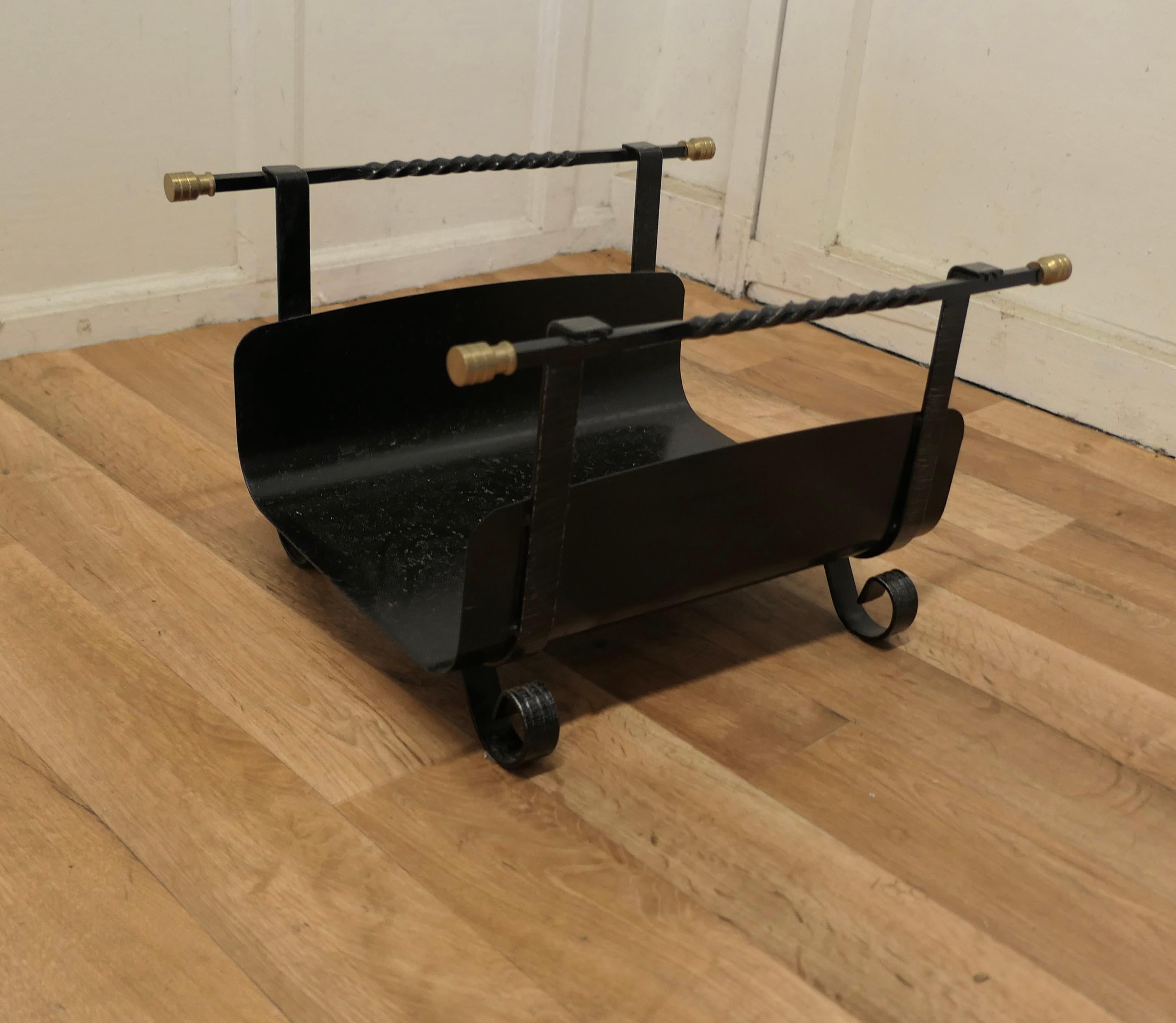 Brass and Iron Log Carrier 

This is a charming piece, it is made in iron and curved to carry logs, it stands on small curled feet and has twisted handles with brass knobs at each end
The Carrier is in good condition, it is 20” long, 12” high and