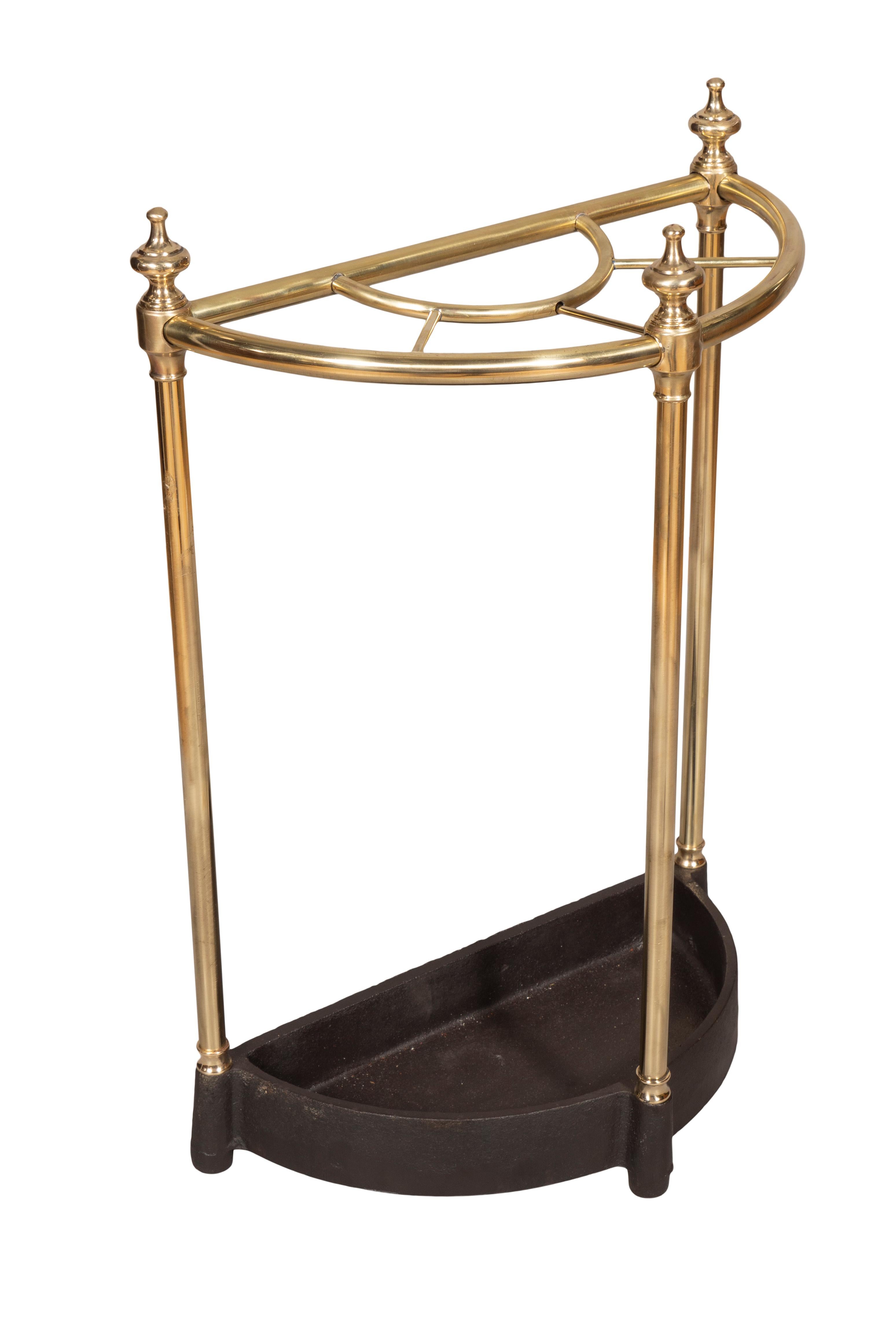 Simple form with cast iron base of a demilune form with a conforming brass frame with finials. Newly polished and cleaned.