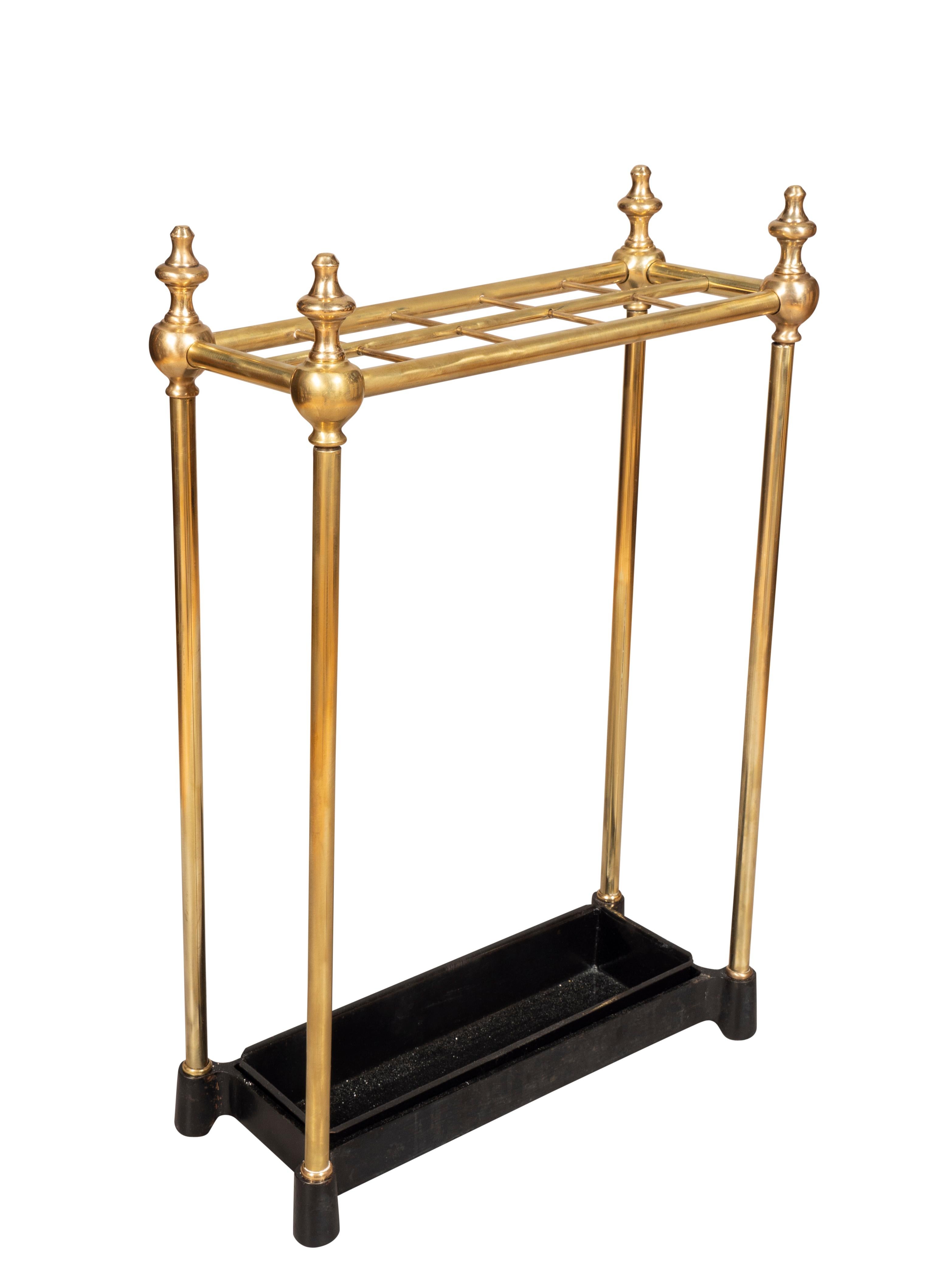 Rectangular with brass finials and sections to hold umbrellas and black iron drip tray. Newly polished and painted.