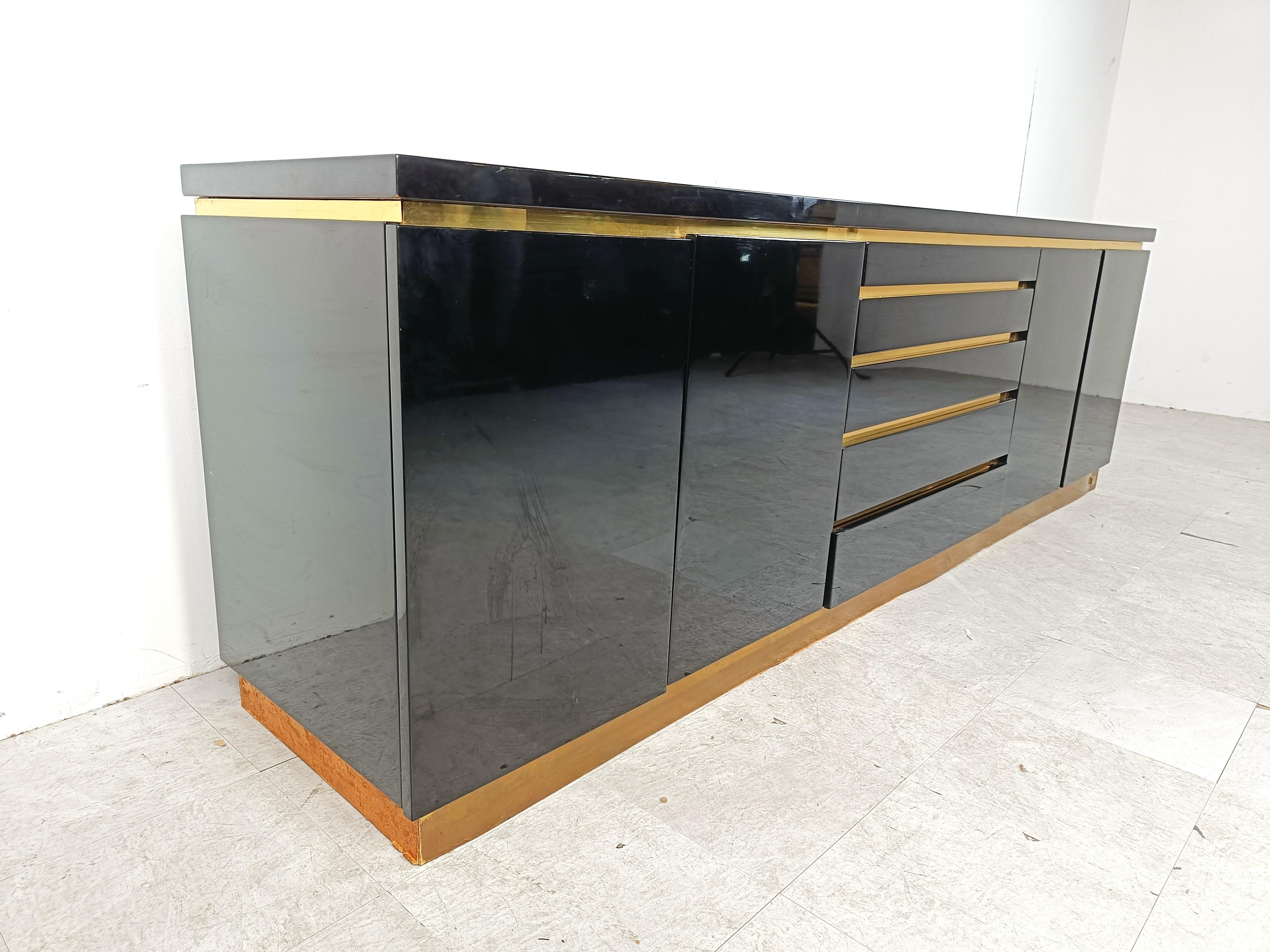 Luxurious seventies glamour sideboard by Jean claude Mahey consitsing of black lacquer panels and brass.

The use of different high quality materials makes this piece very attractive.

The sideboard offers plenty of storage space

Good condition