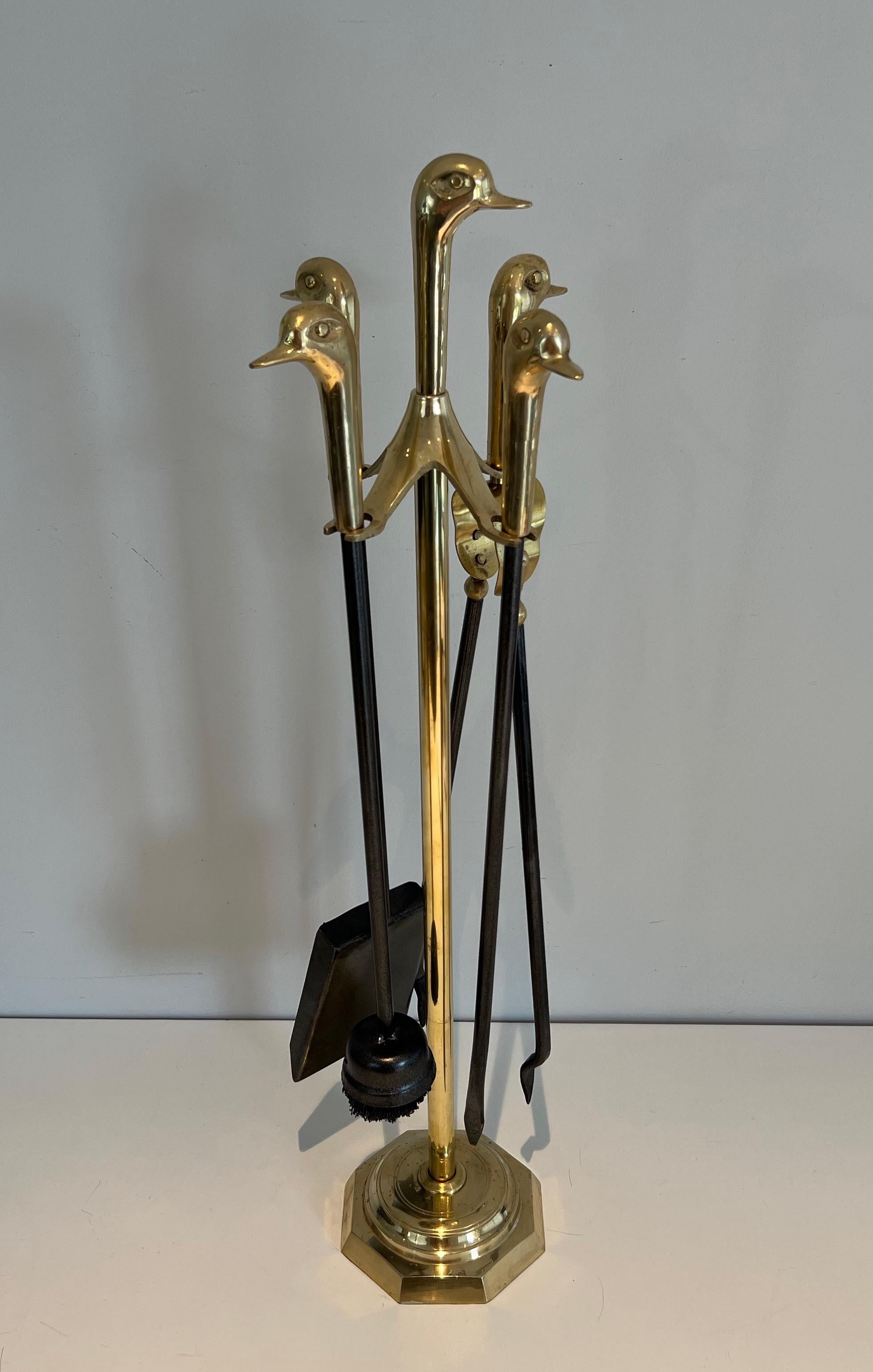These neoclassical style duck heads fireplace tools on stand are made of black lacquered metal and brass. This is a French work. Circa 1970.