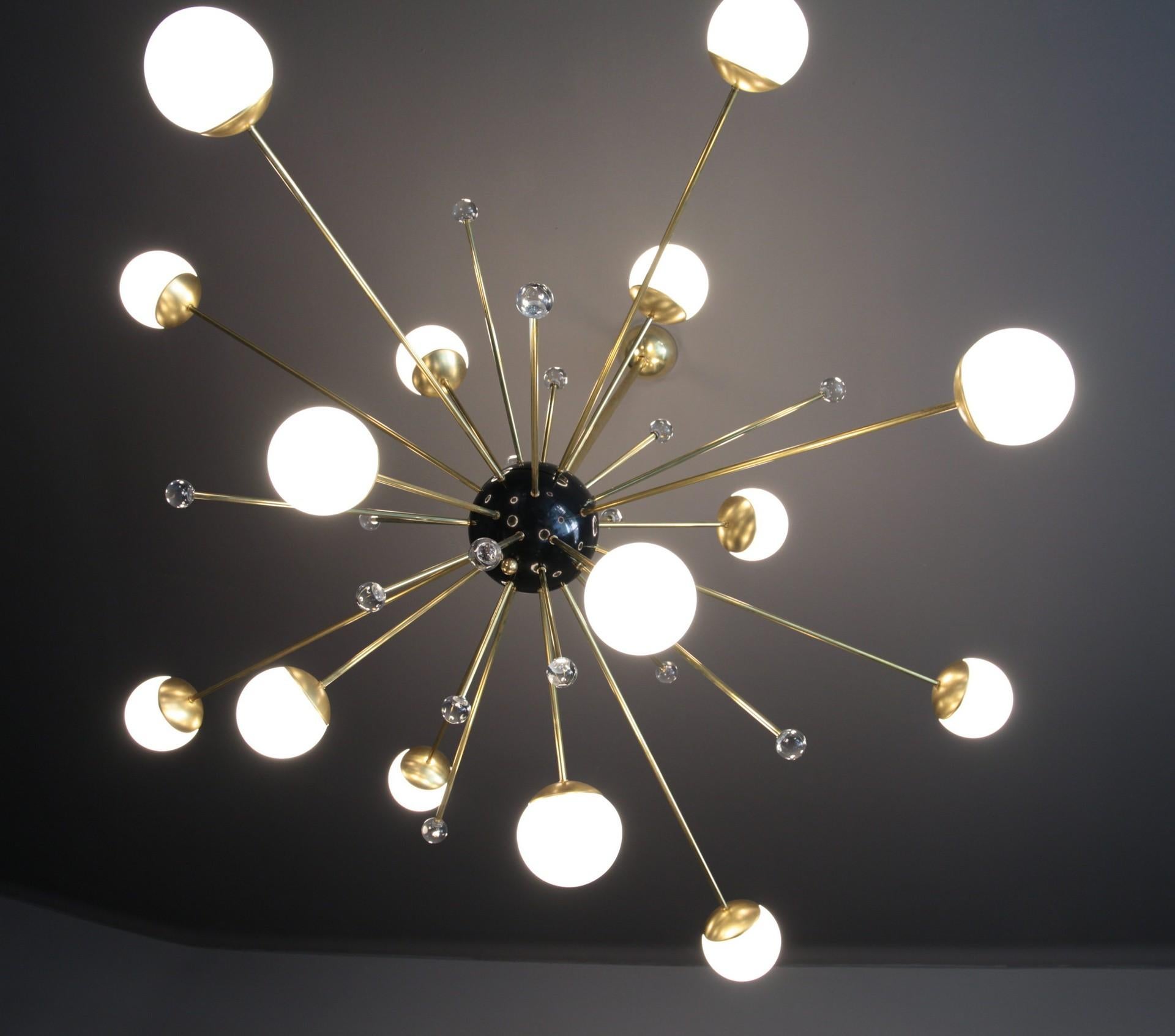 A wonderful design that enhances the sputnik design. Here the light comes from 16 opaline Venetian glass blown spheres. There are also correspondent massiccio glass globes that are refracting the light creating a magic play with light. 

The black